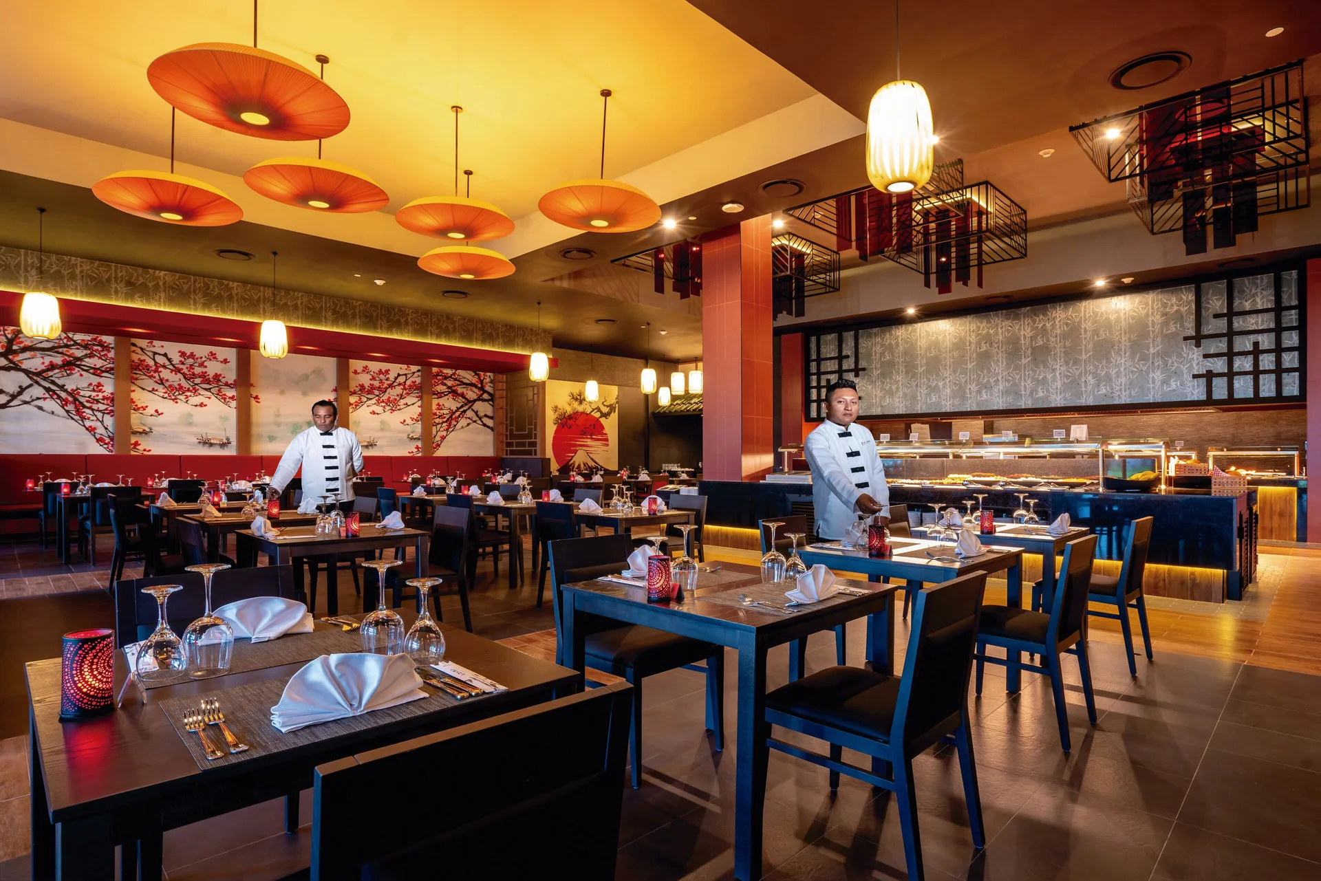 Asian-style dining room with set tables and buffet counter at Hotel Riu Latino.