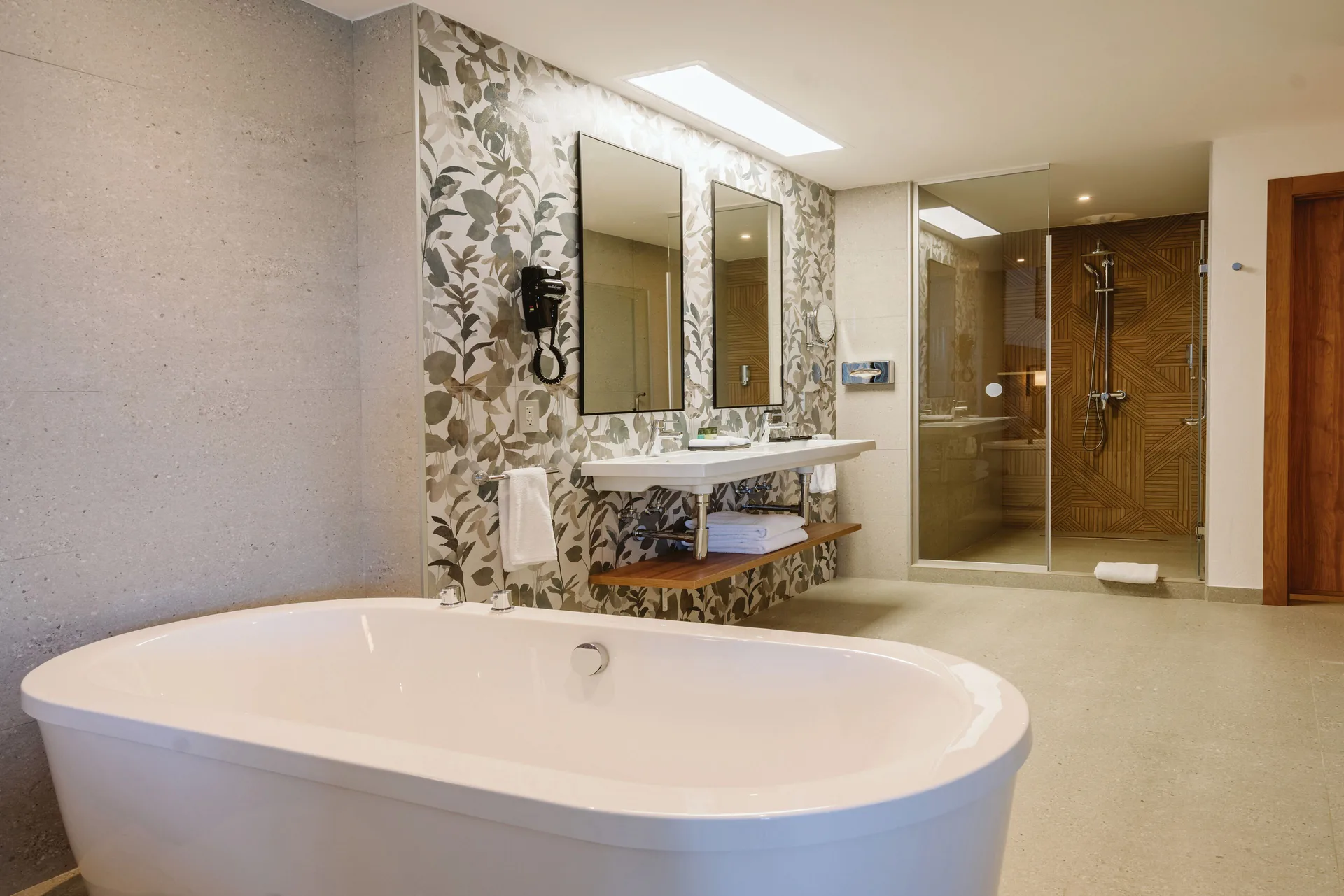 Ocean View Suite bathroom at Hotel Riu Latino with freestanding tub, double sink, and glass shower.