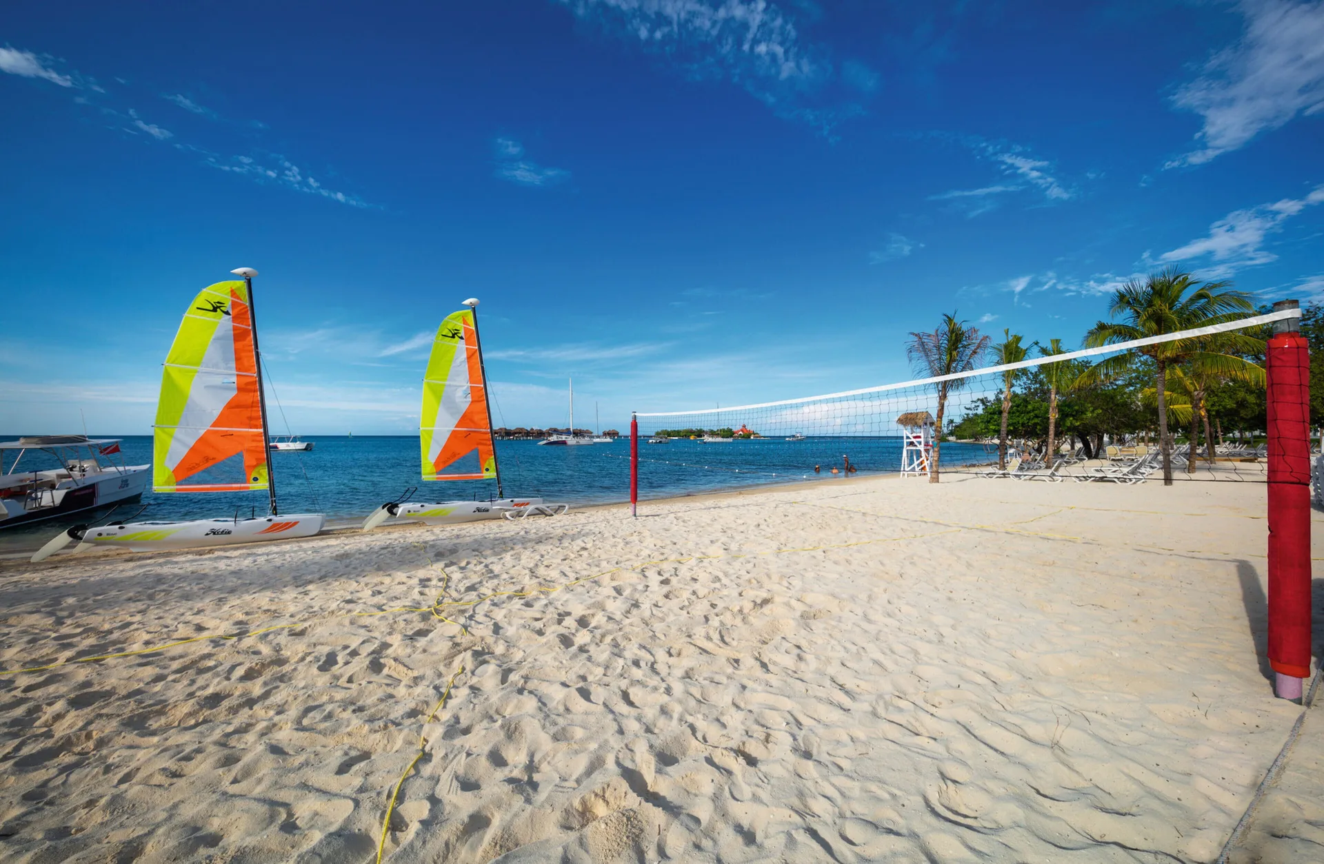 Beach volleyball net and sailboats on the sand at Hotel Riu Montego Bay.