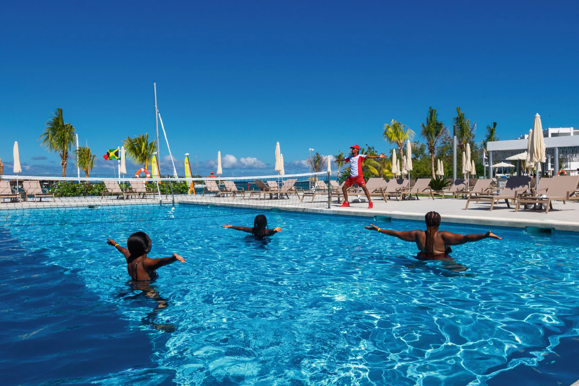 Pool fitness class with instructor beside the water at Hotel Riu Montego Bay.