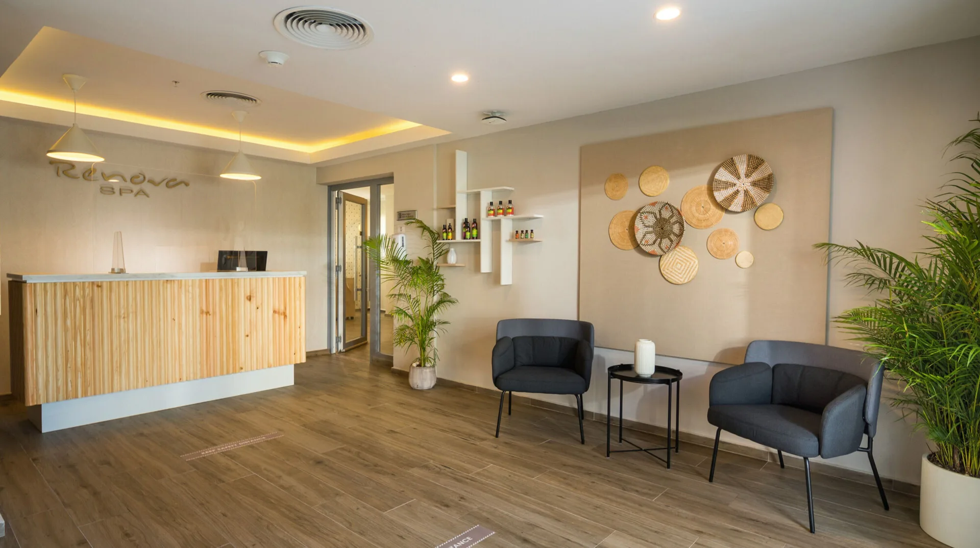 Spa reception with seating and woven wall decor at Hotel Riu Montego Bay.