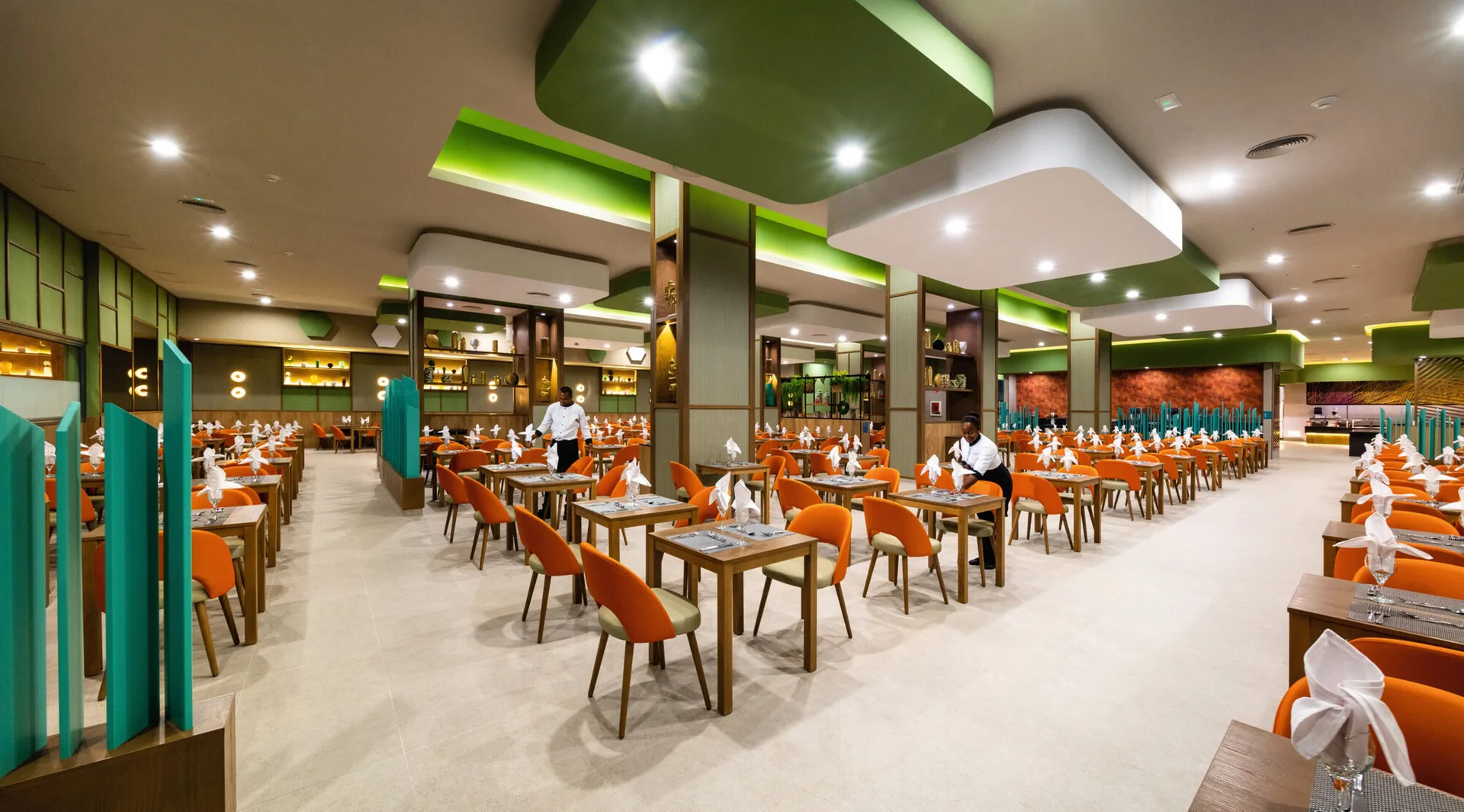 Large buffet restaurant dining room with orange chairs at Hotel Riu Montego Bay.