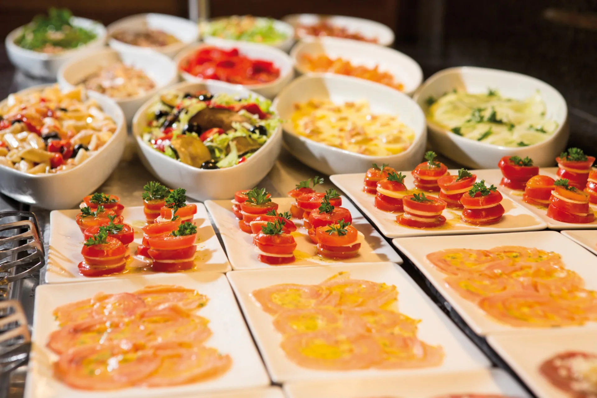 Close-up of tomato stacks, sliced cold plates, and salads at Hotel Riu Montego Bay.