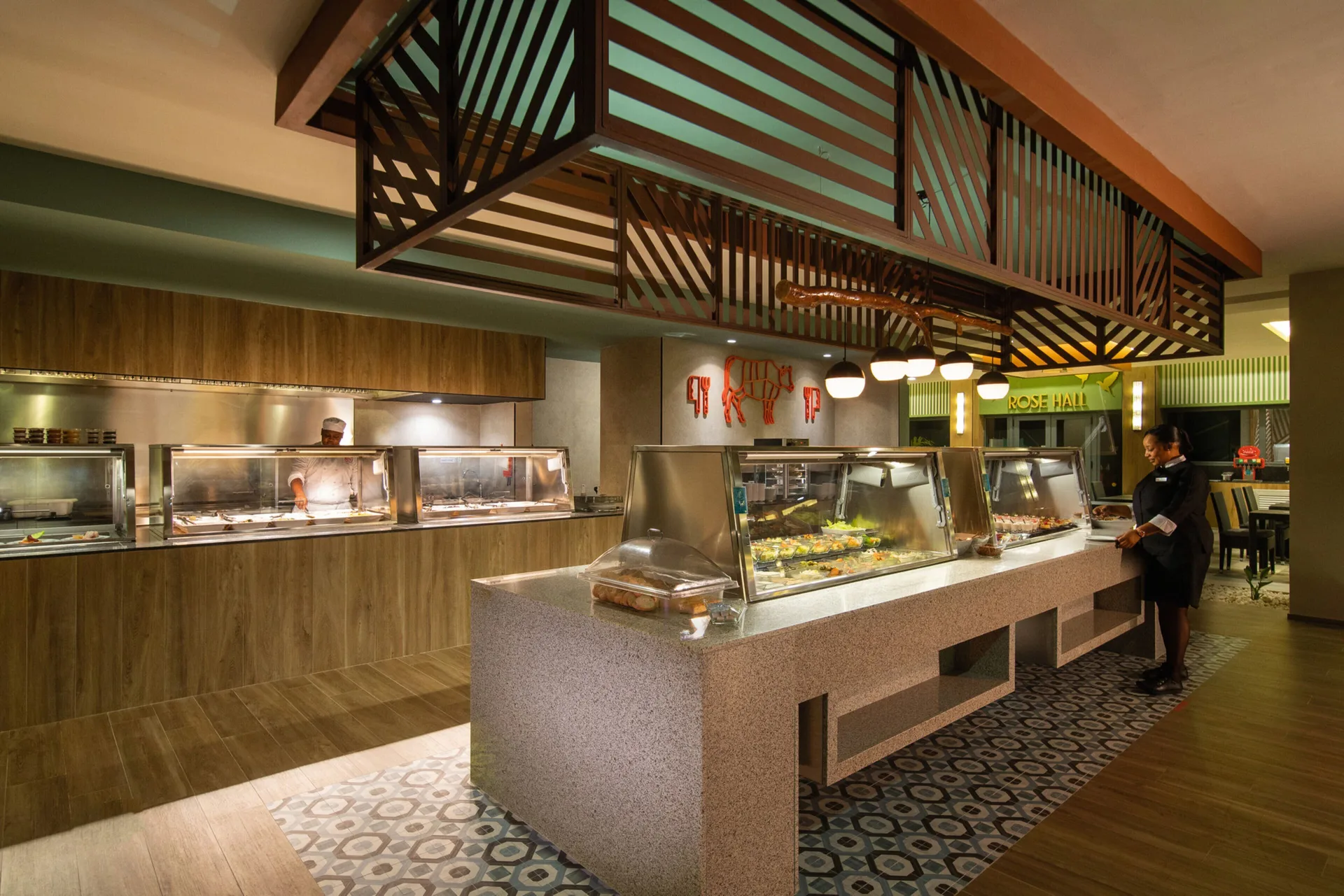 Buffet counters with Rose Hall sign visible at Hotel Riu Montego Bay.