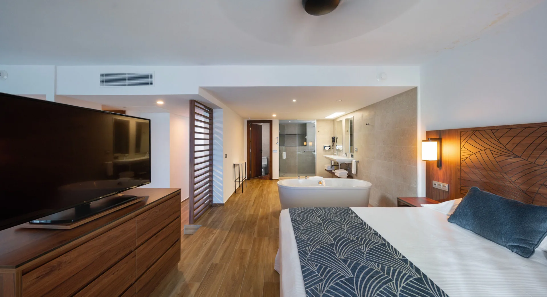 Suite Ocean View with king bed, TV, and freestanding tub at Hotel Riu Montego Bay.