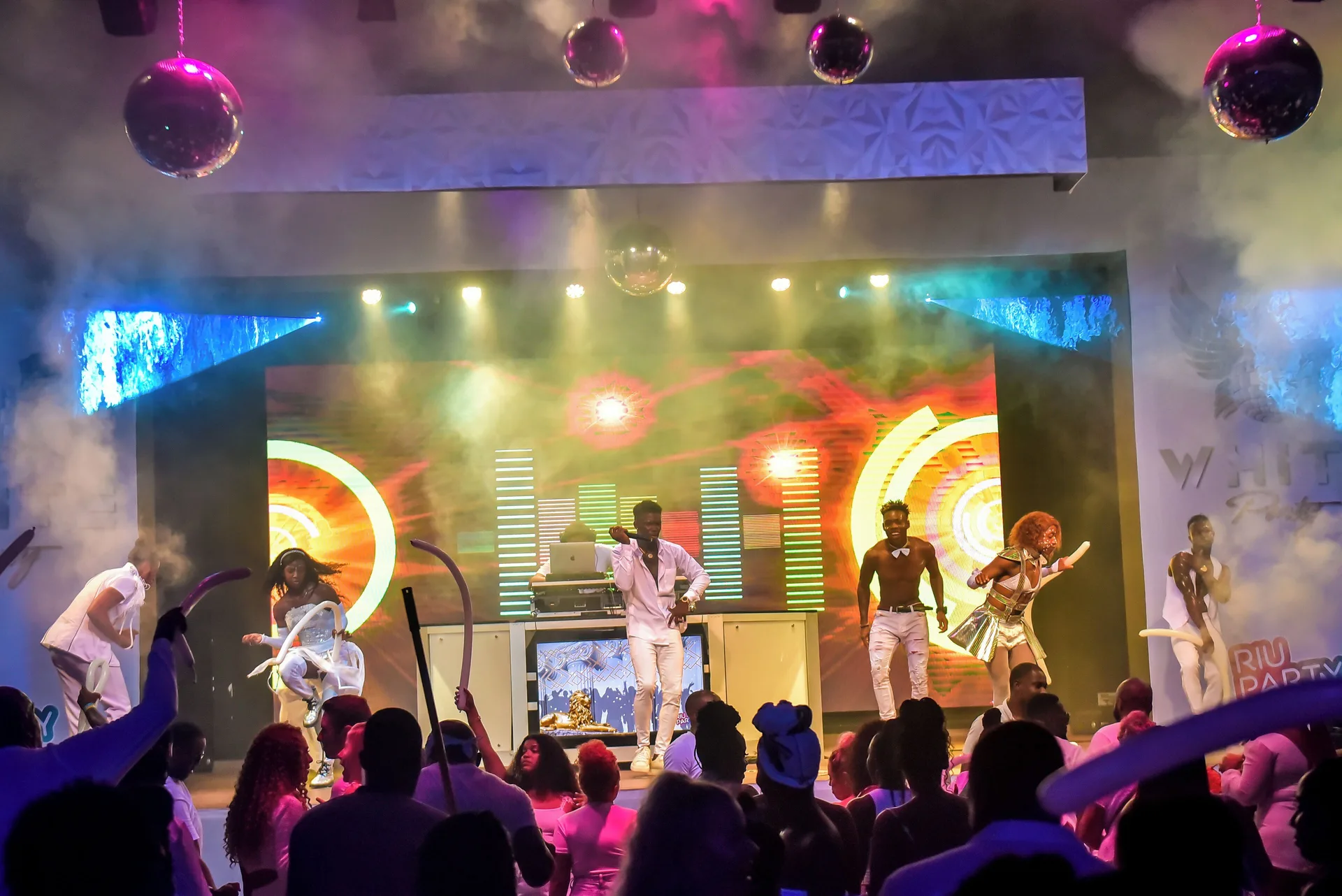 Live stage performance with dancers, lights, and smoke at Hotel Riu Montego Bay.