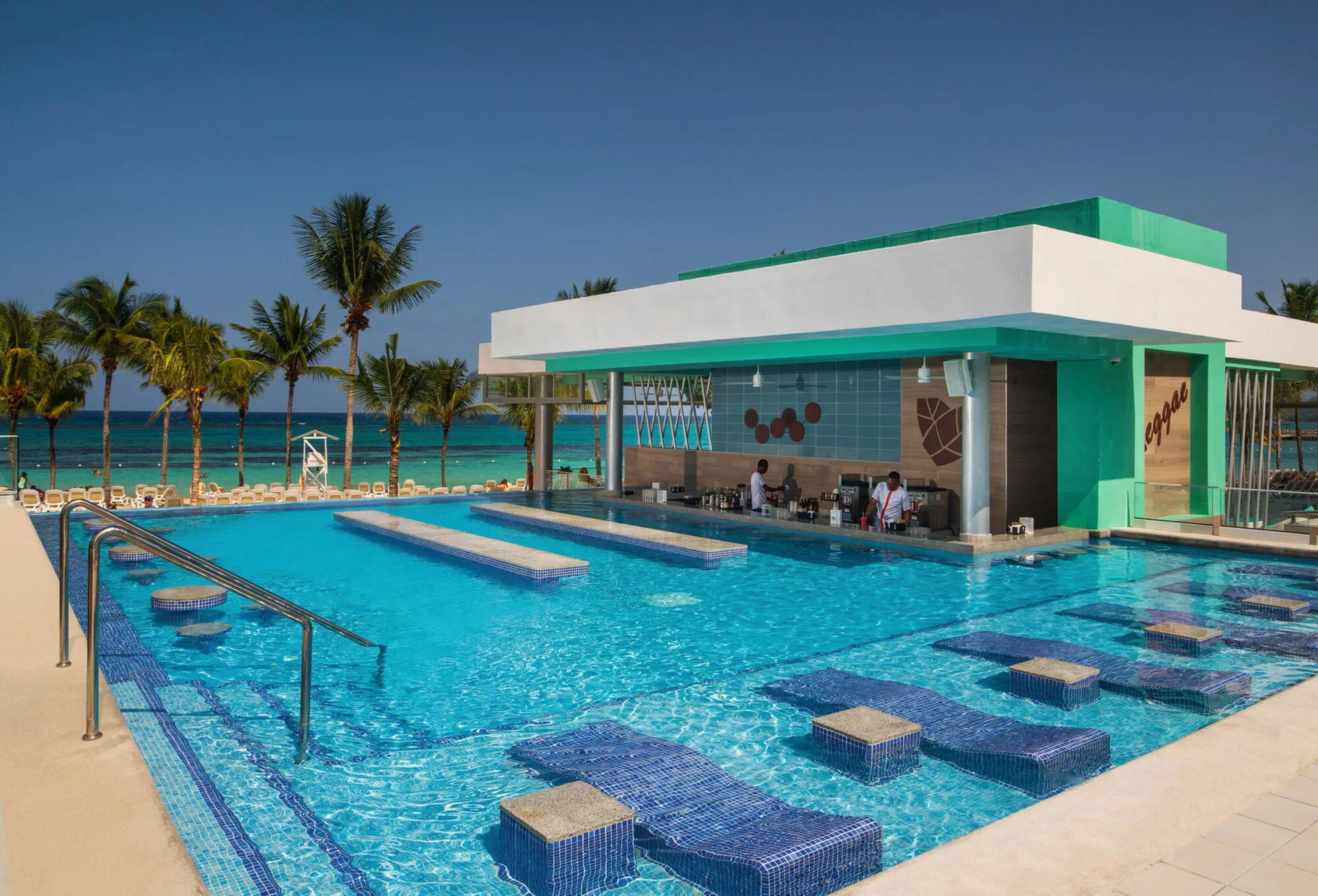Quiet pool with in-water loungers and a swim-up bar at Hotel Riu Ocho Rios.