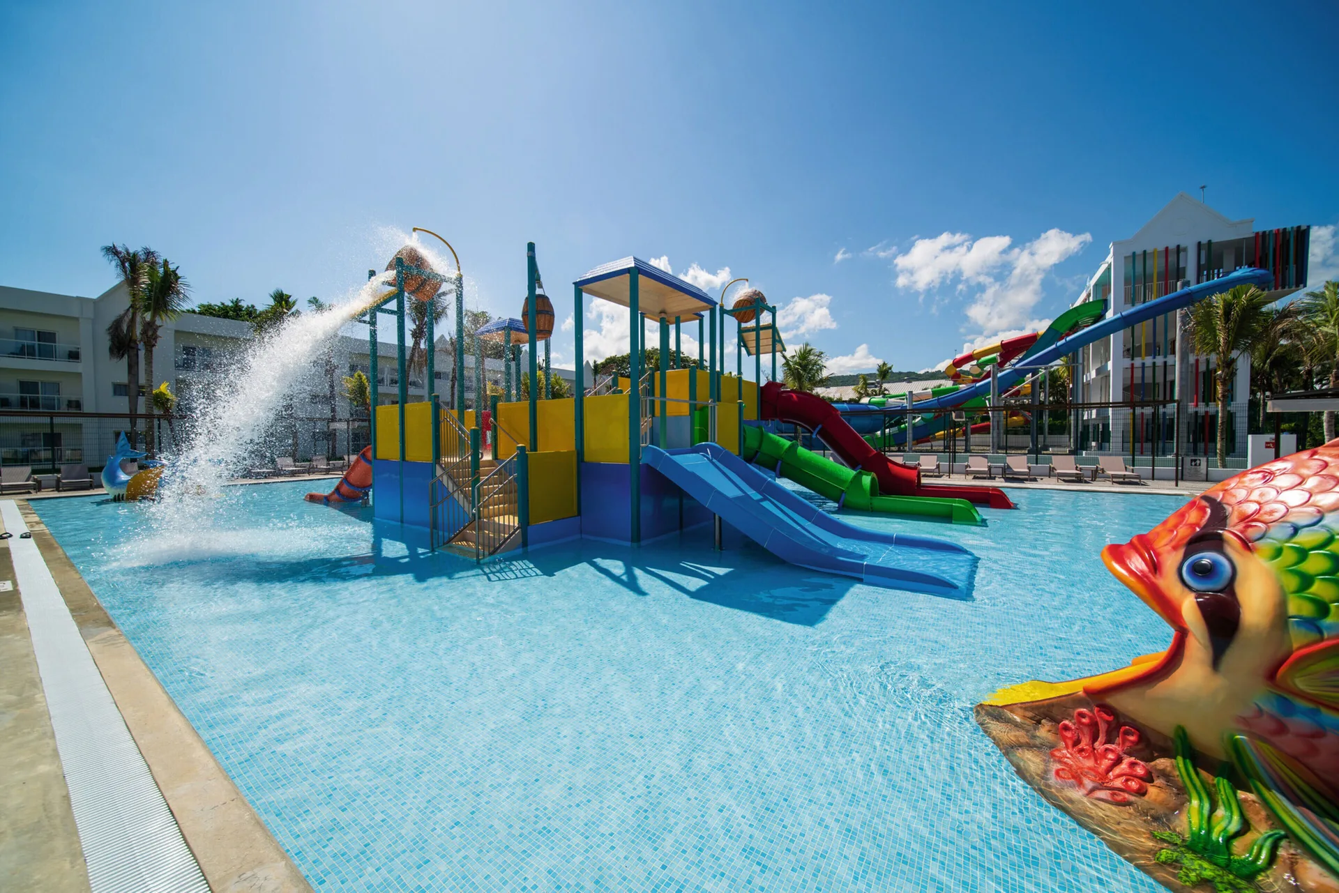 Splash pool play area with slides, water buckets and a fish feature at Hotel Riu Ocho Rios.