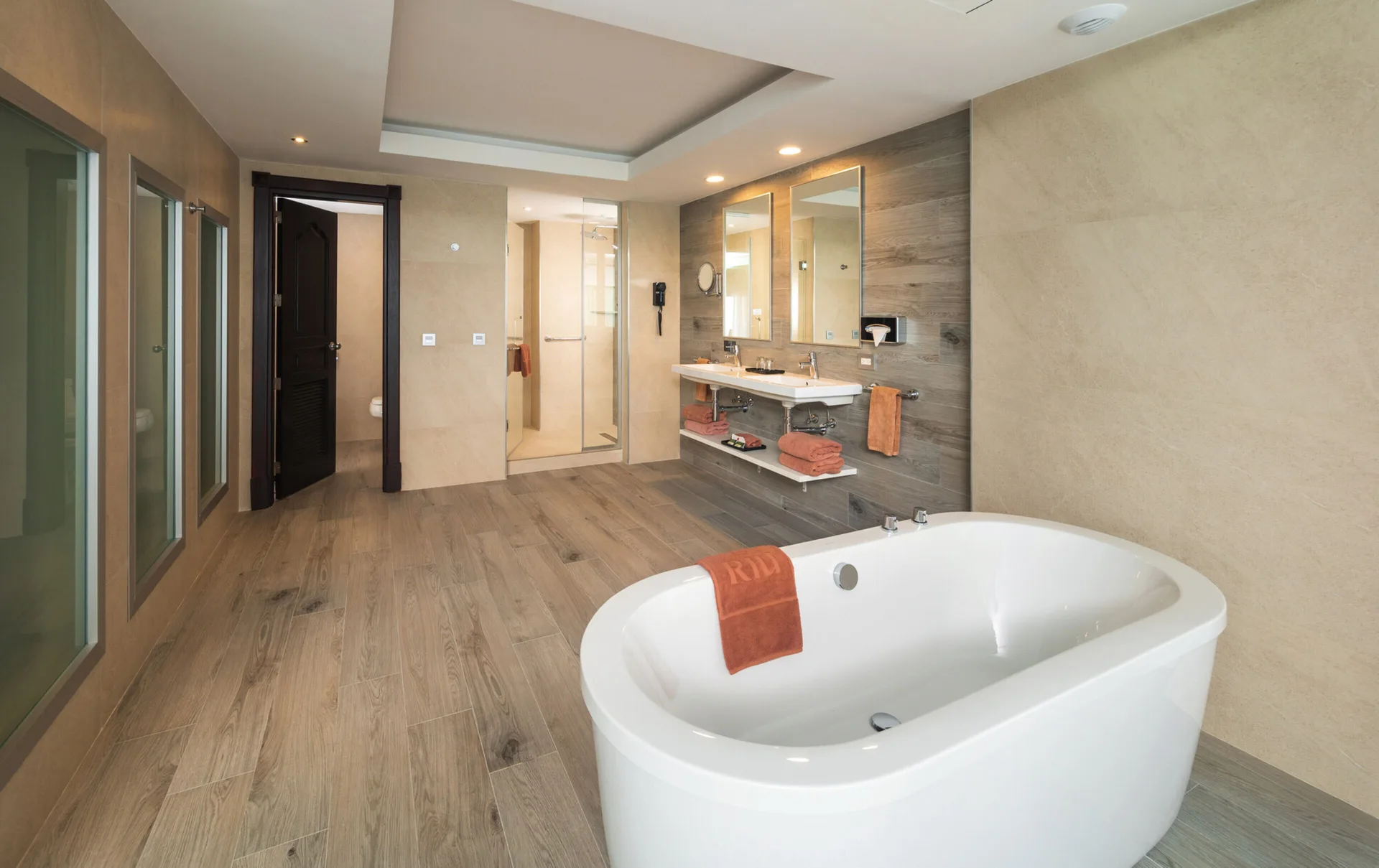 Ocean View Suite bathroom with freestanding tub, shower and double vanity at Hotel Riu Ocho Rios.