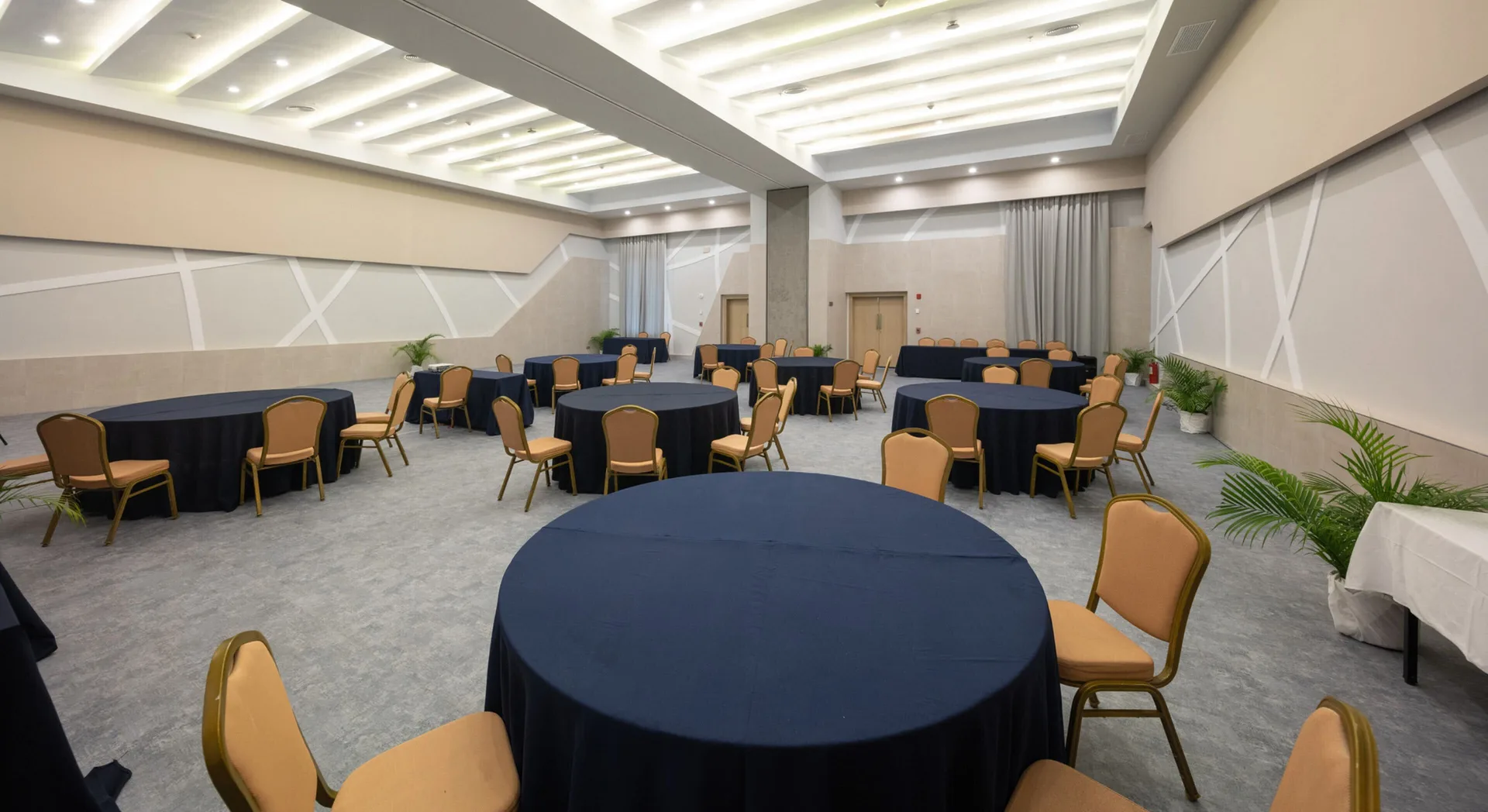 Event room with round tables and navy linens at Hotel Riu Ocho Rios.
