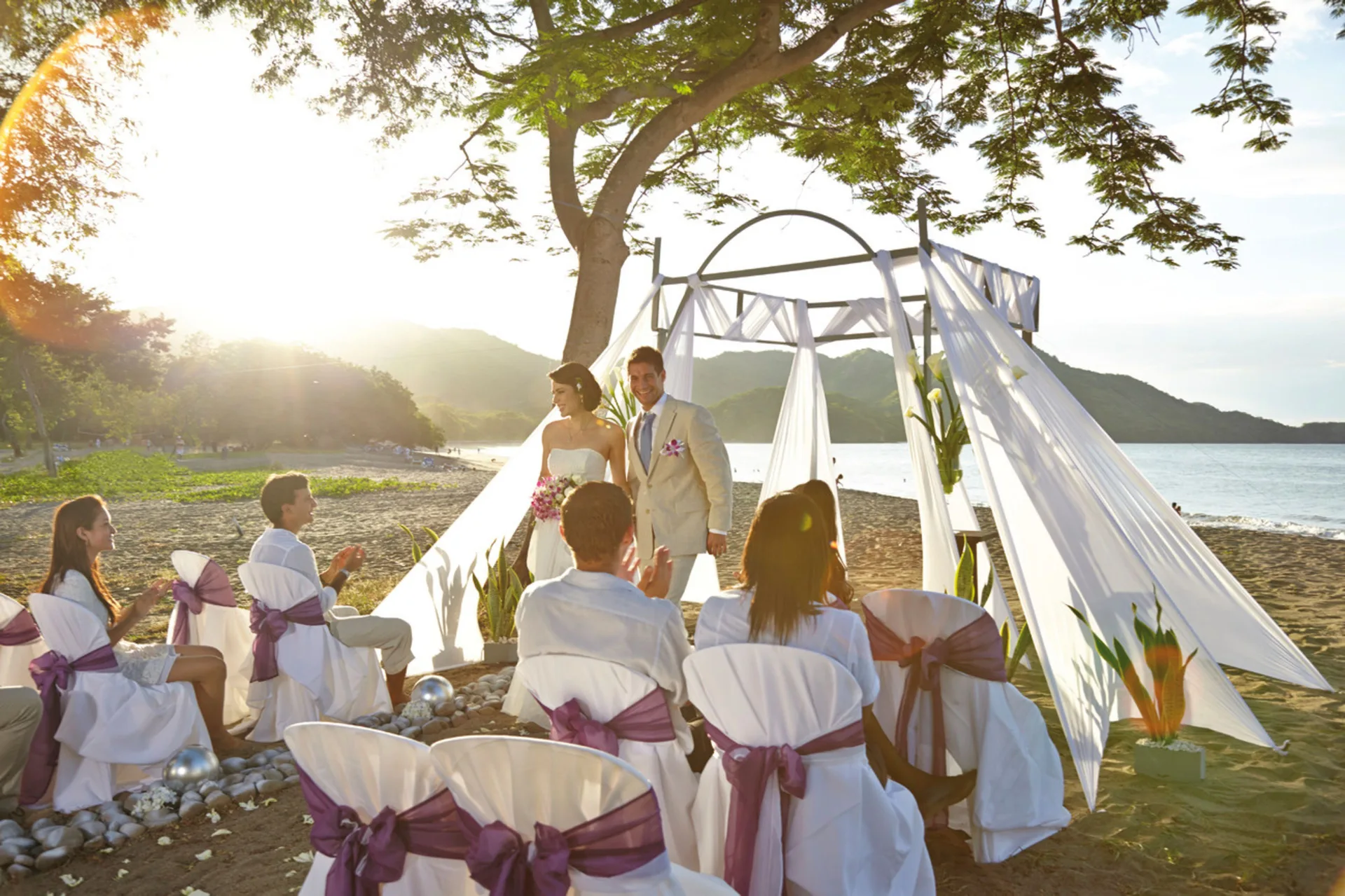 Beach wedding ceremony setup with seated guests at Hotel Riu Palace Costa Rica.
