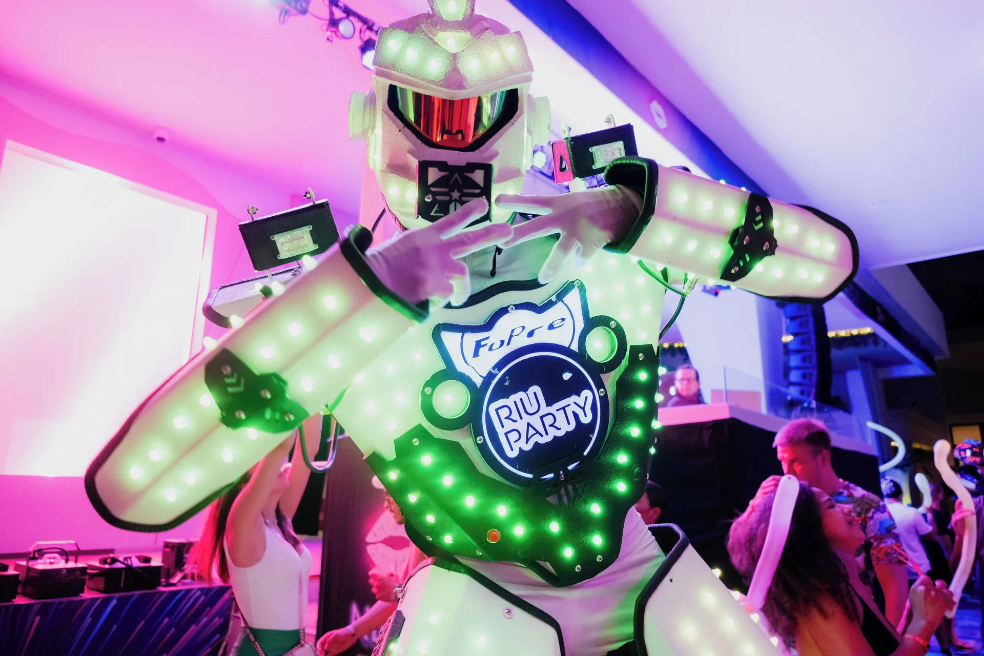 An LED-costumed performer poses during a party at Hotel Riu Palace Peninsula.