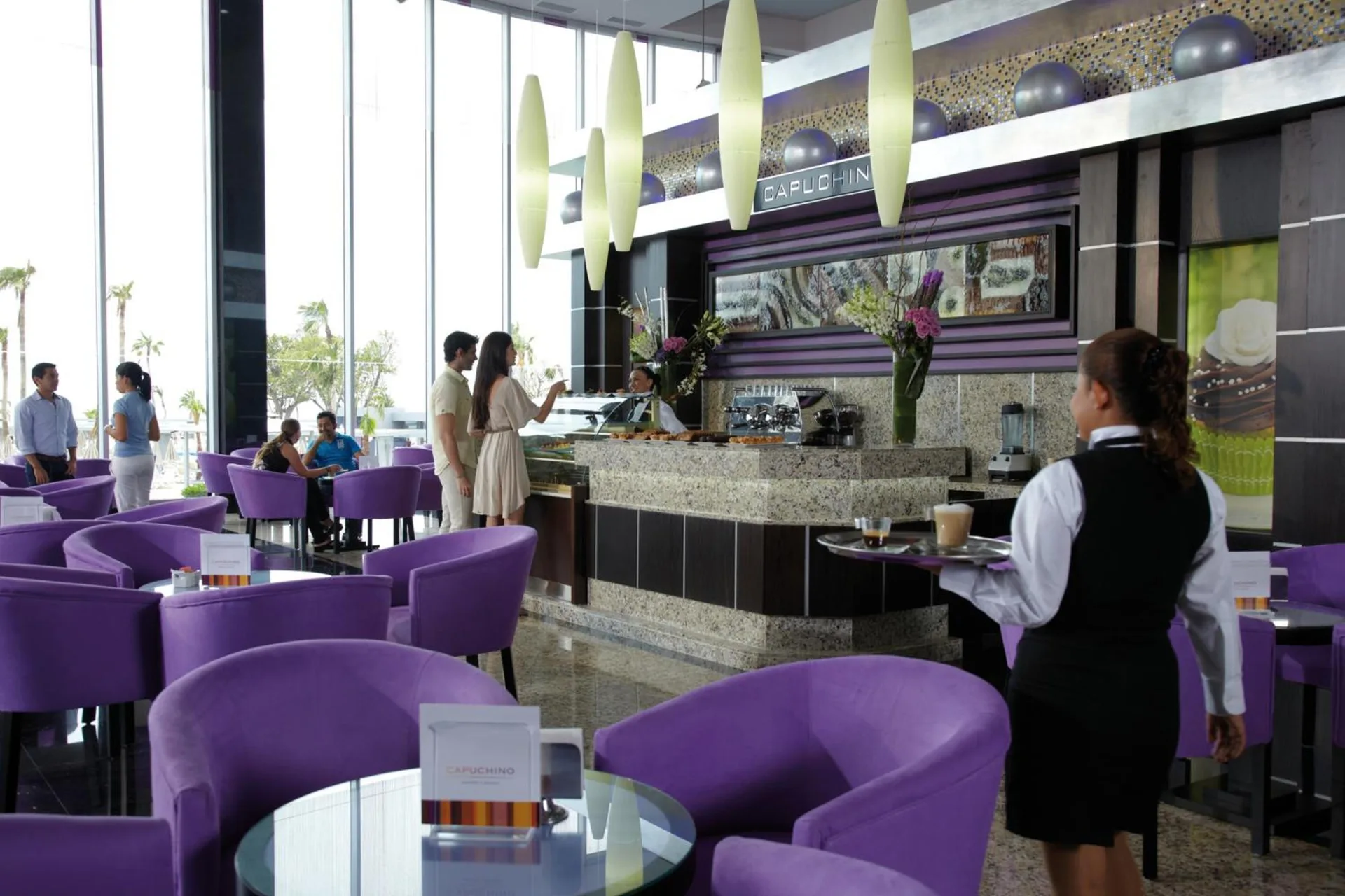 Capuchino cafe seating and pastry counter at Hotel Riu Palace Peninsula.