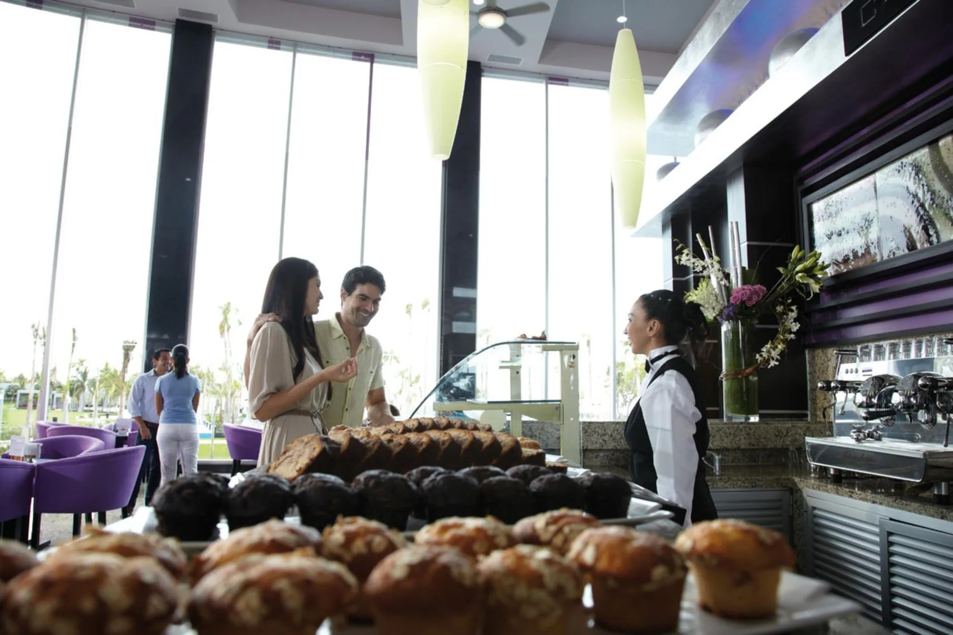 Pastry display and guests at Capuchino cafe in Hotel Riu Palace Peninsula.