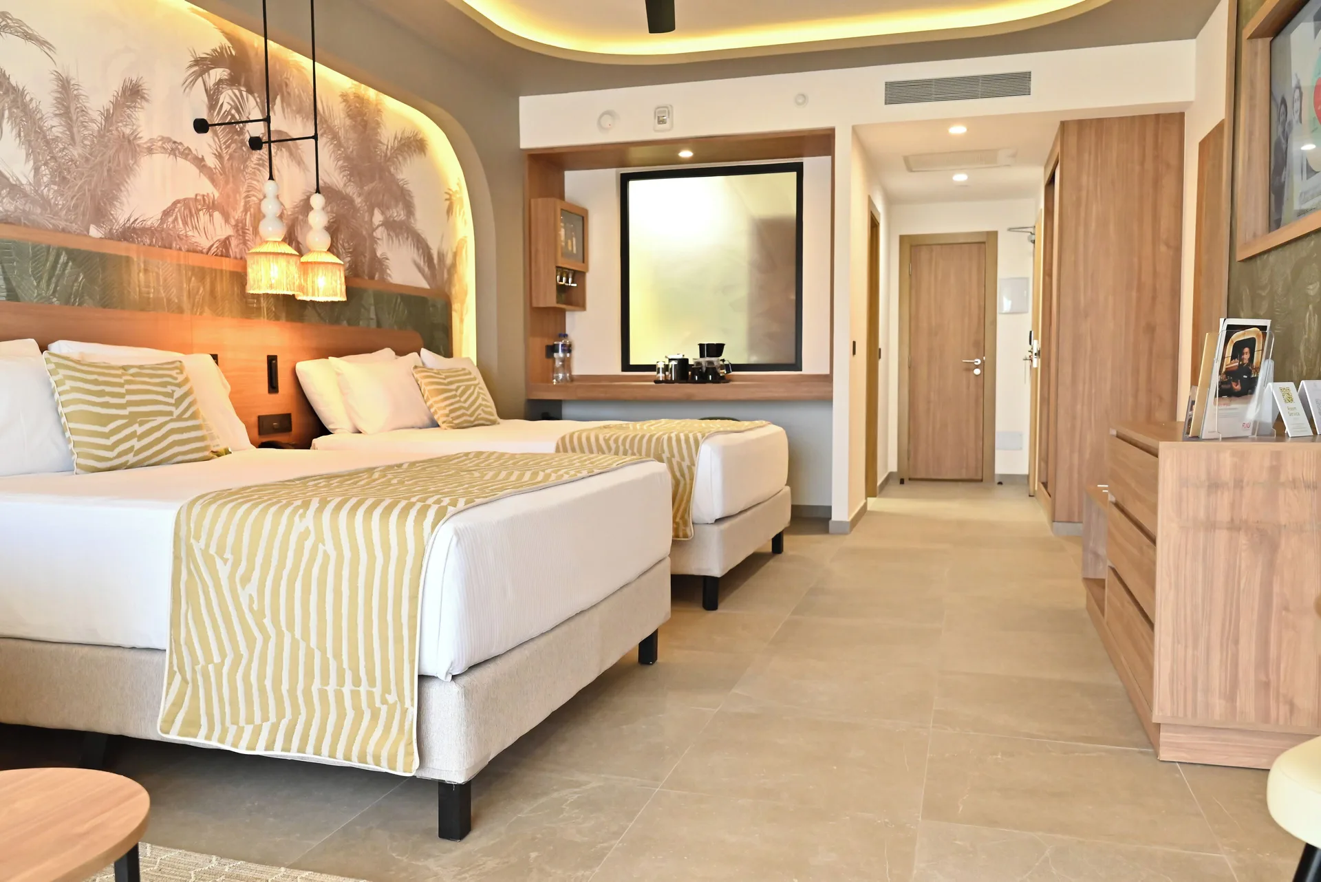Junior Suite Garden View with two beds and entry hall at Hotel Riu Palace Peninsula.