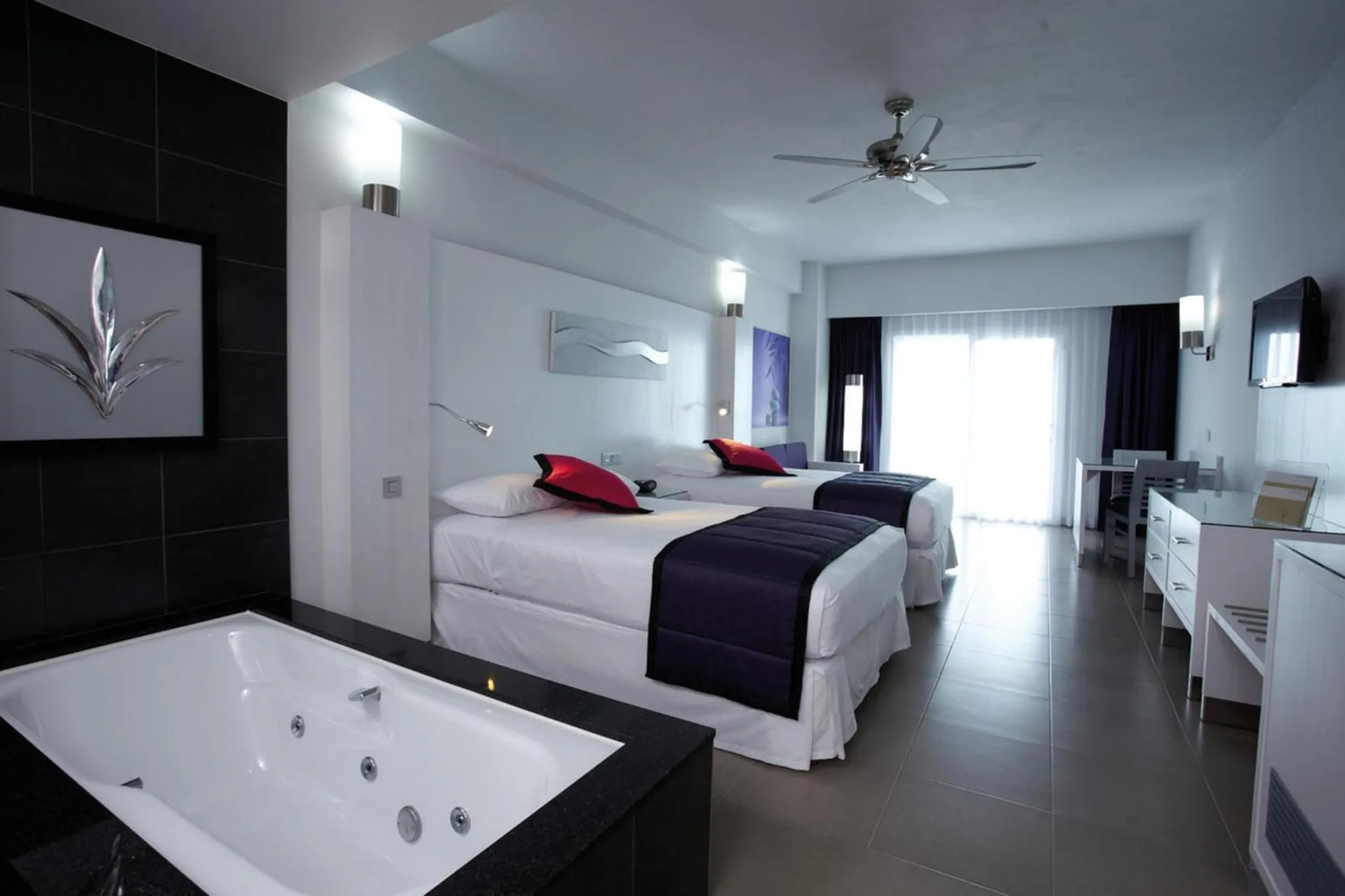 Junior Suite with two beds and in-room tub at Hotel Riu Palace Peninsula.