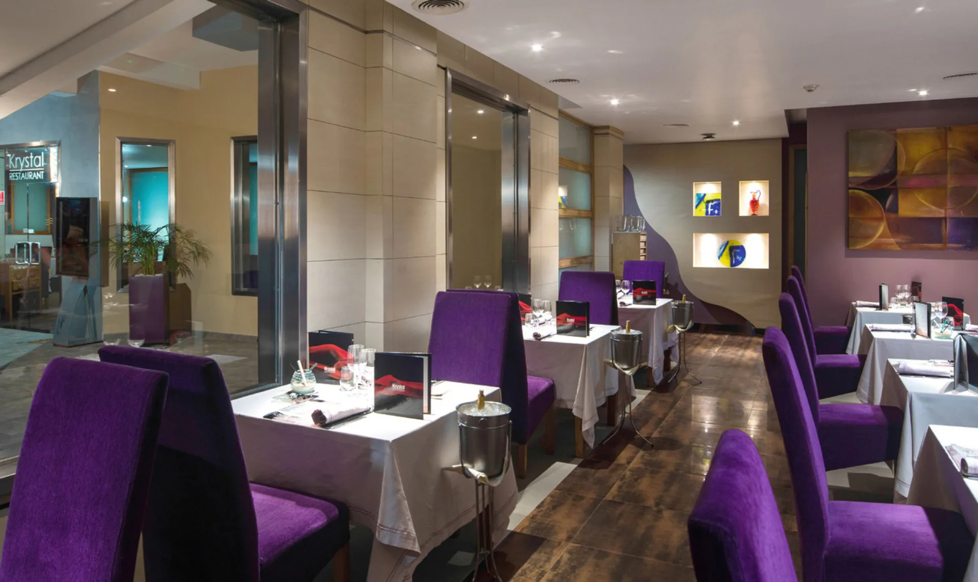 Krystal dining room with purple chairs at Hotel Riu Palace Tropical Bay.