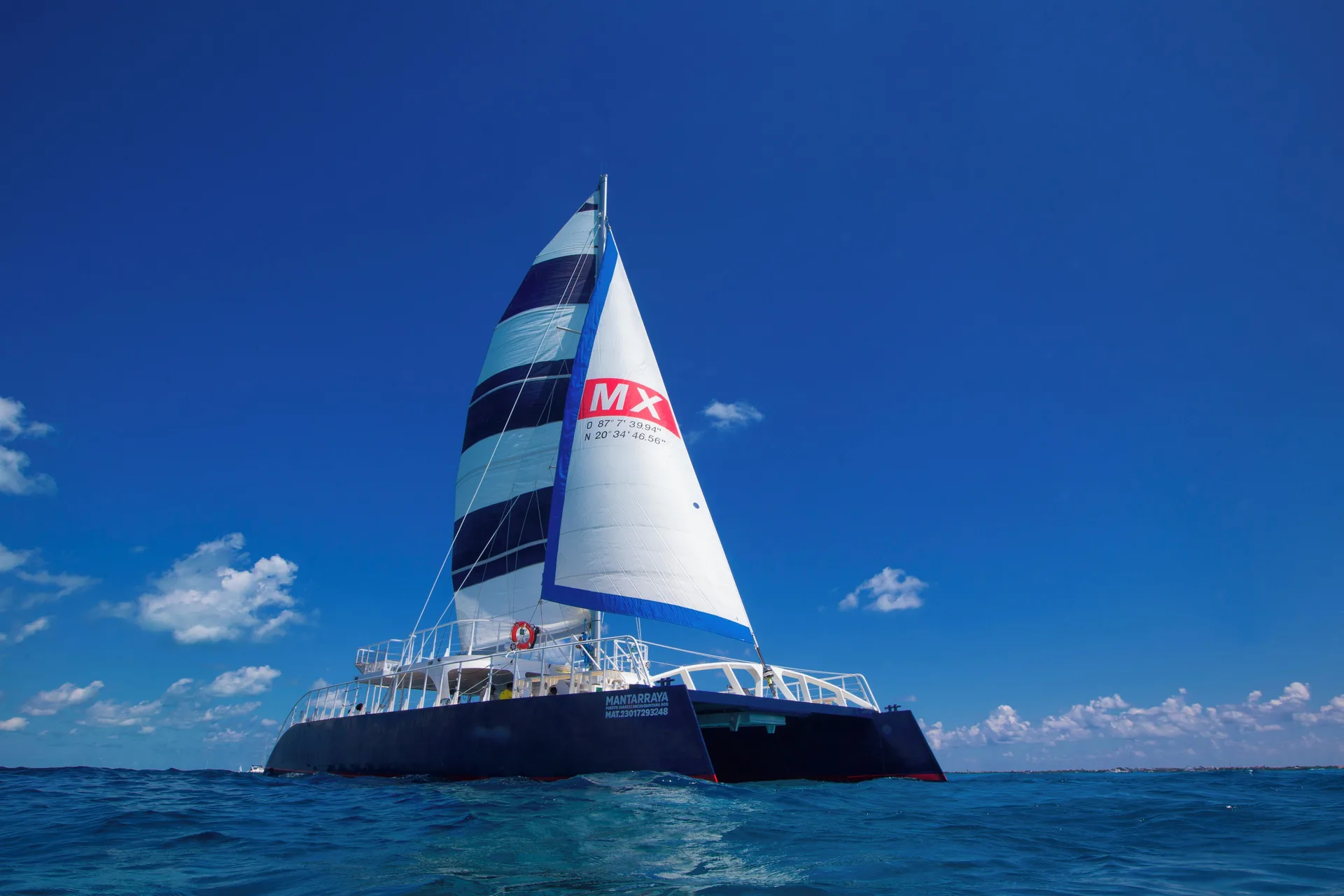 Sailboat on blue ocean water near Hotel Xcaret Arte.