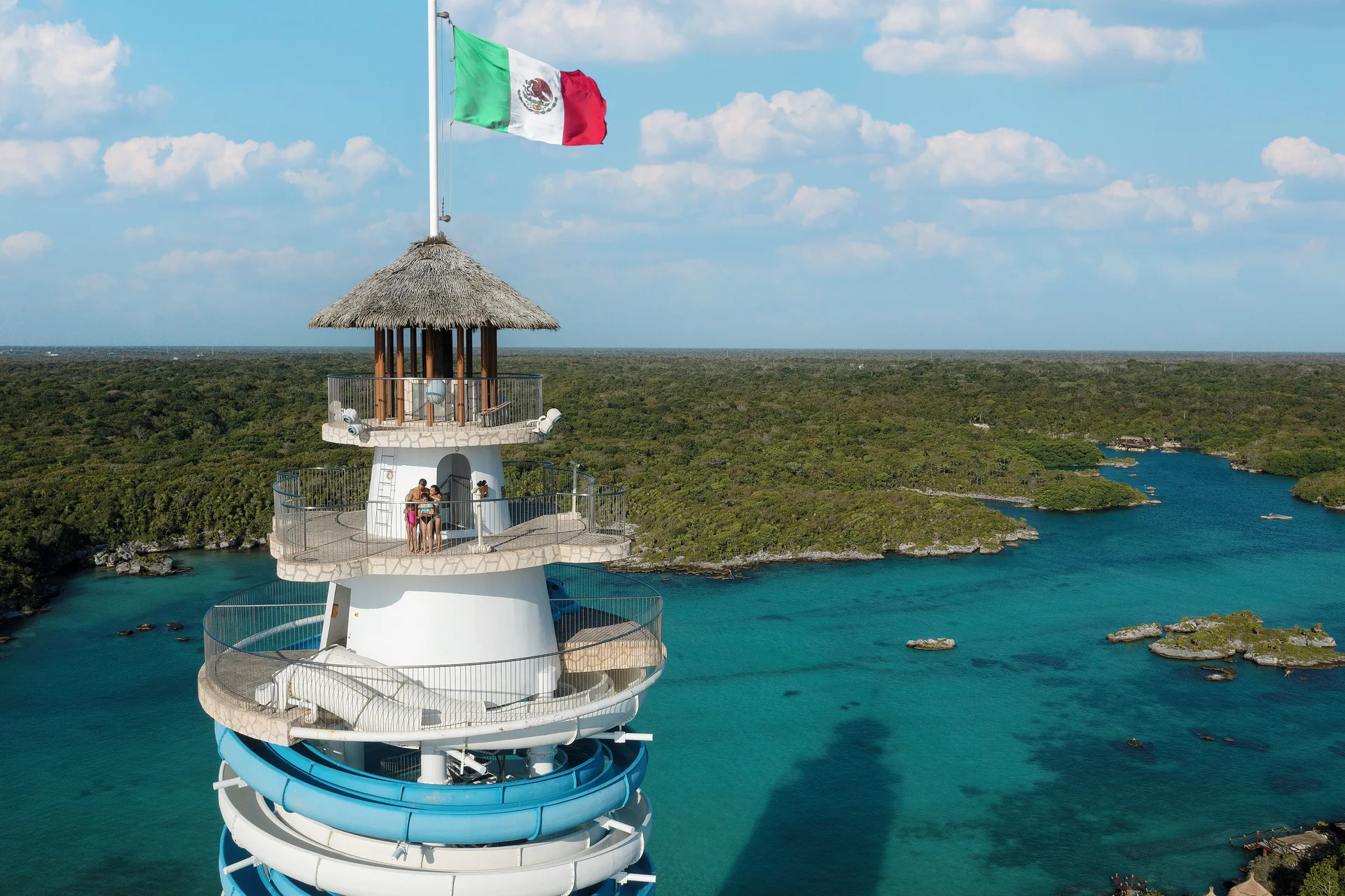 Close aerial view of a spiral tower and lagoon landscape at Hotel Xcaret Arte.