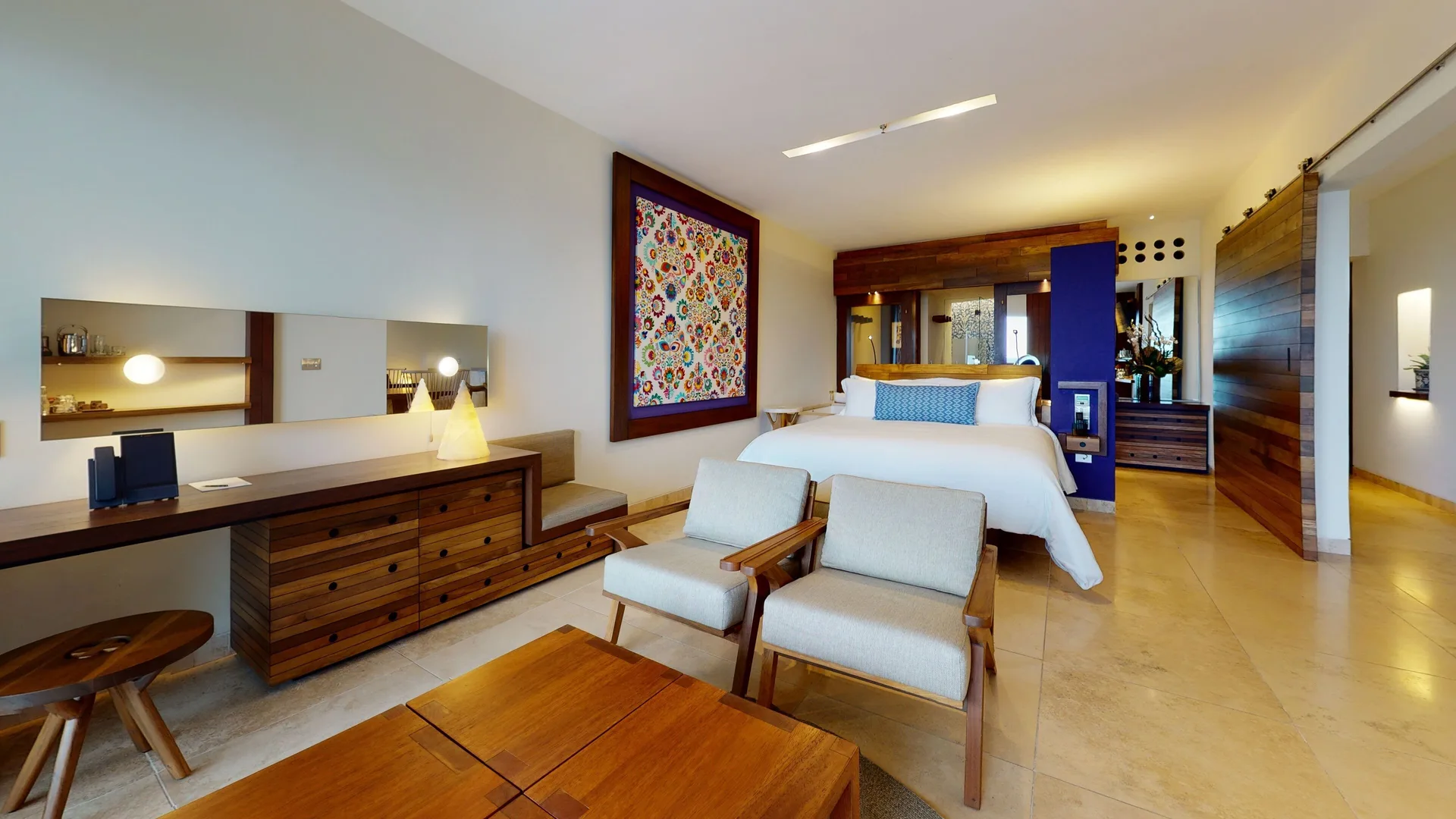 Junior Suite Ocean View with king bed, seating area, desk, and wood furnishings at Hotel Xcaret Arte.