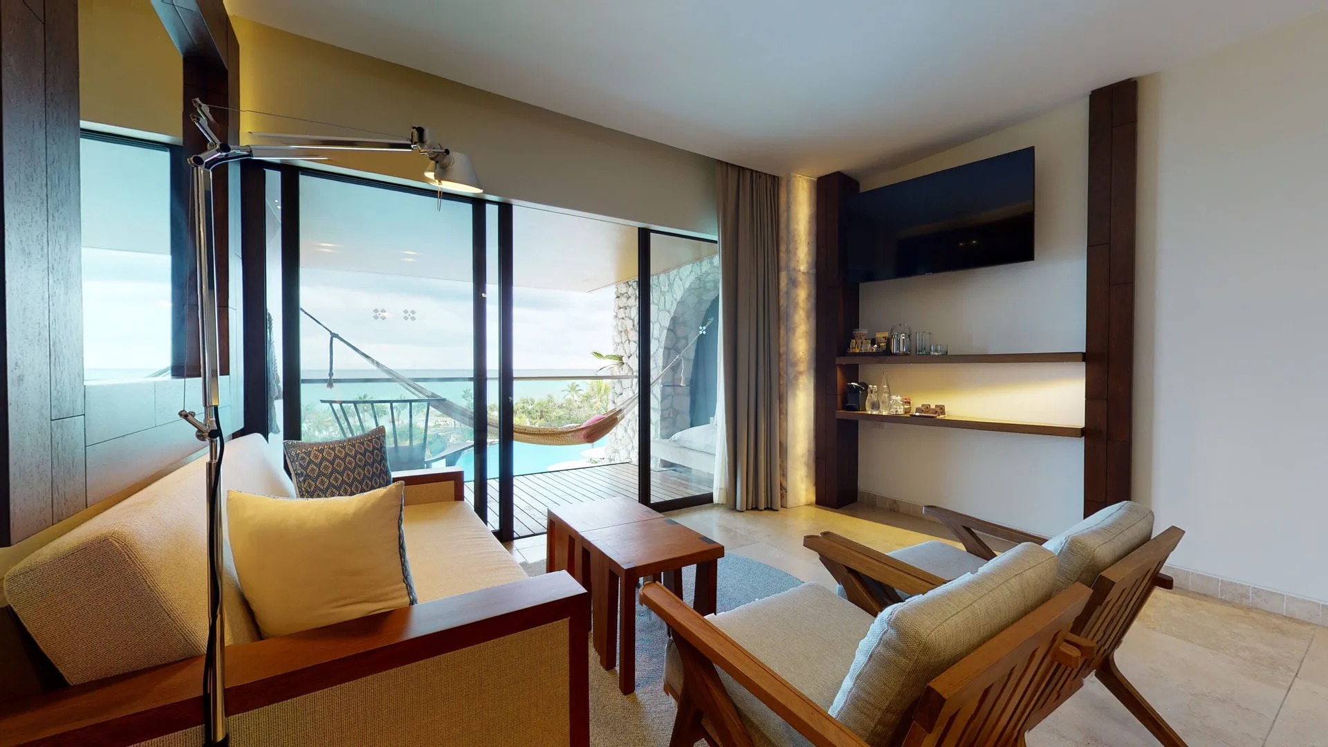 Junior Suite Ocean View living area with balcony hammock and sea view at Hotel Xcaret Arte.