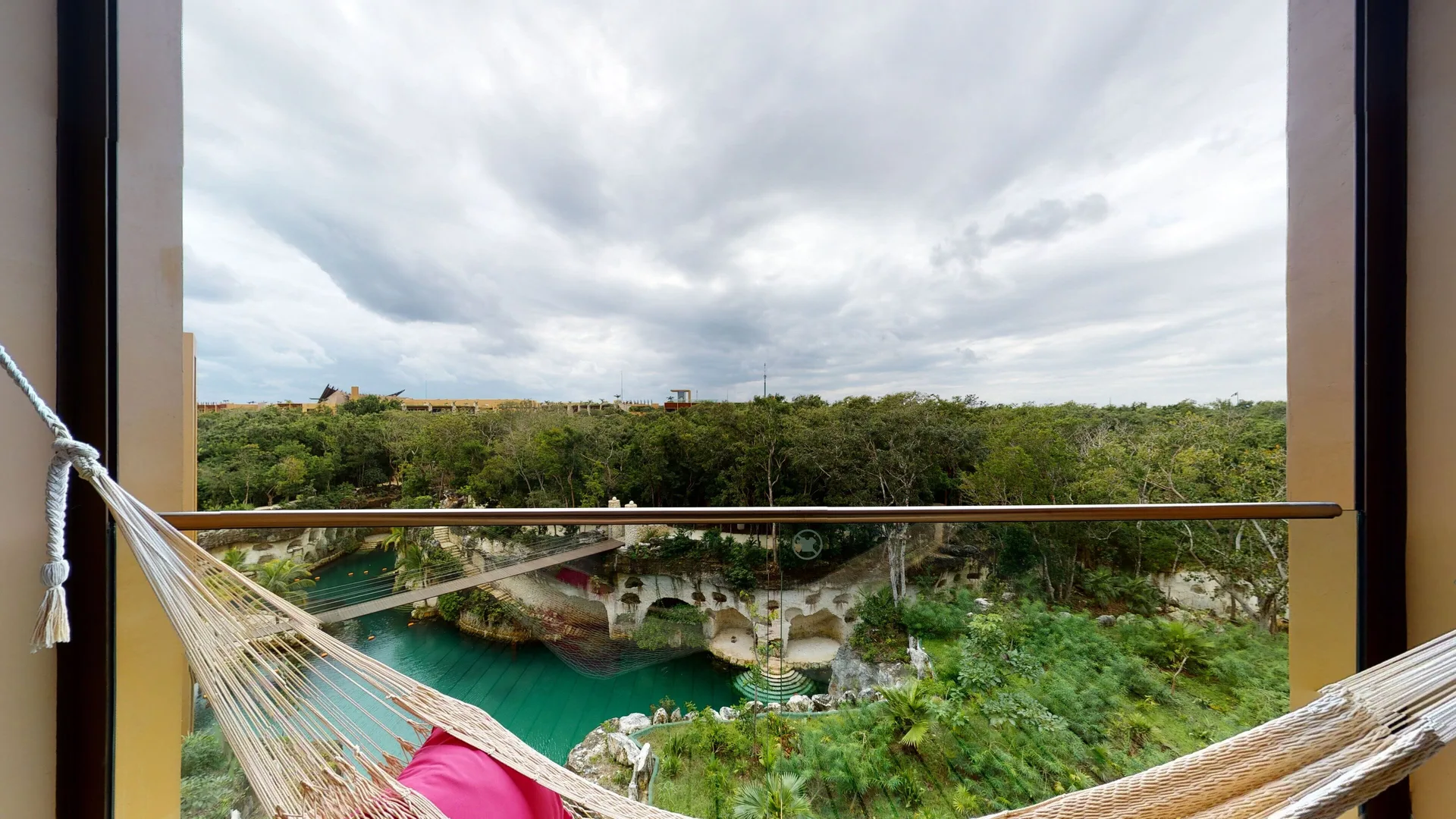 Junior Suite River Spa balcony view at Hotel Xcaret Arte with hammock, turquoise water, and greenery