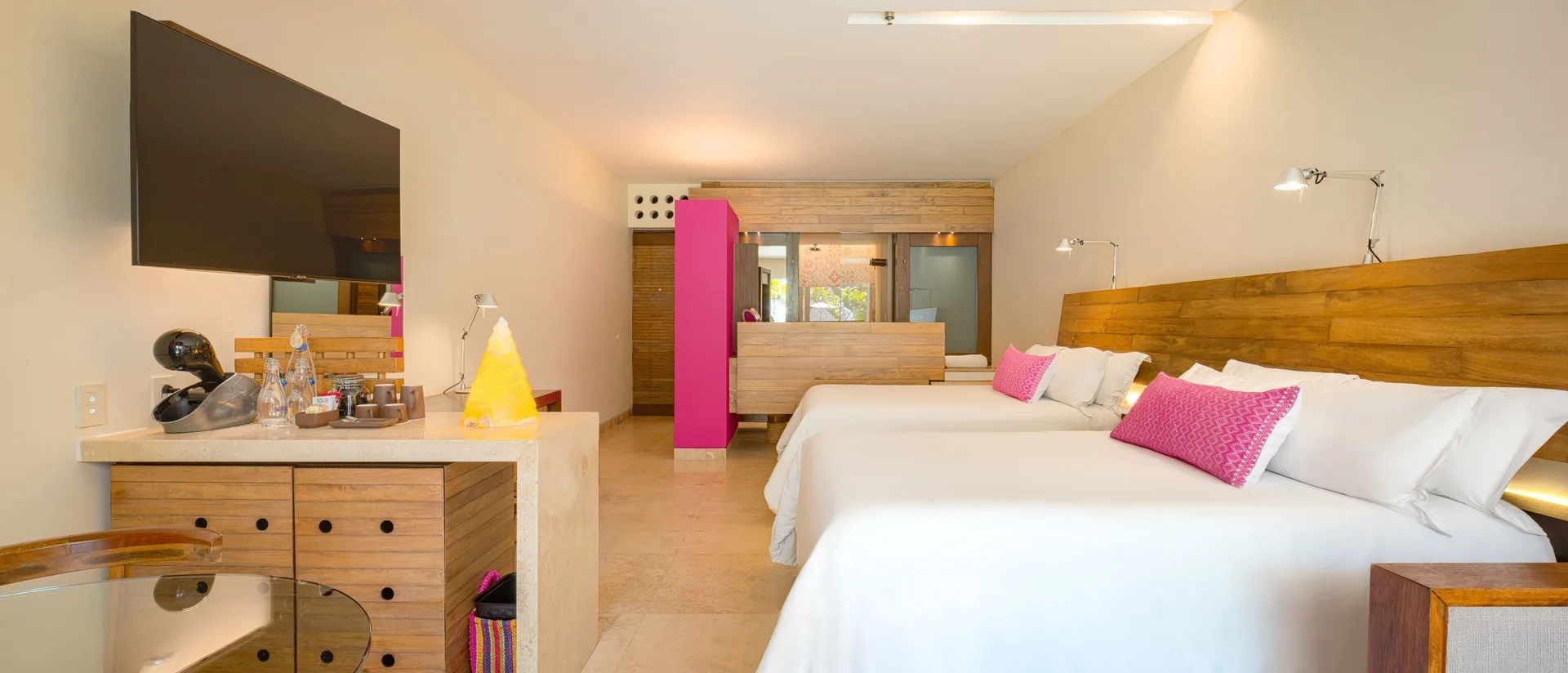 Garden Swim Up room with two double beds, TV, and vanity at Hotel Xcaret Arte.