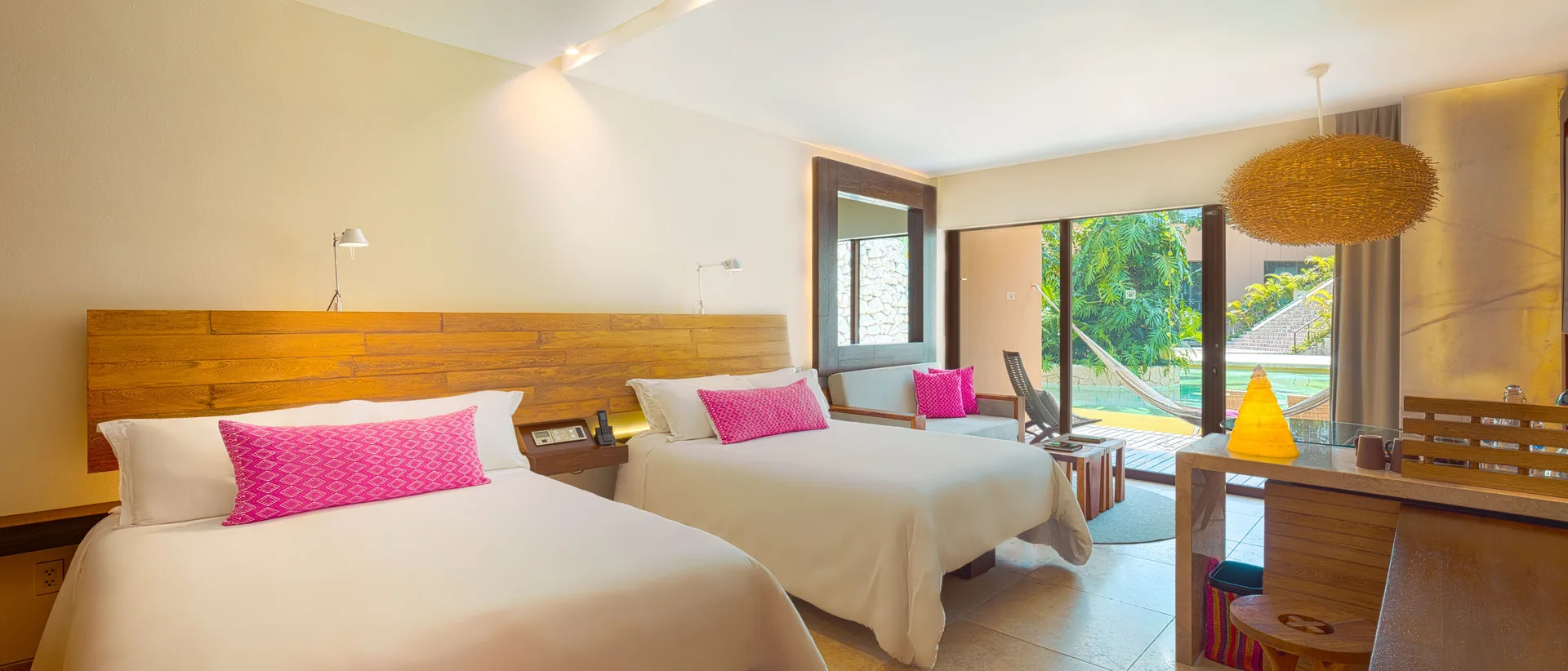 Garden Swim Up room with two double beds and terrace view at Hotel Xcaret Arte.
