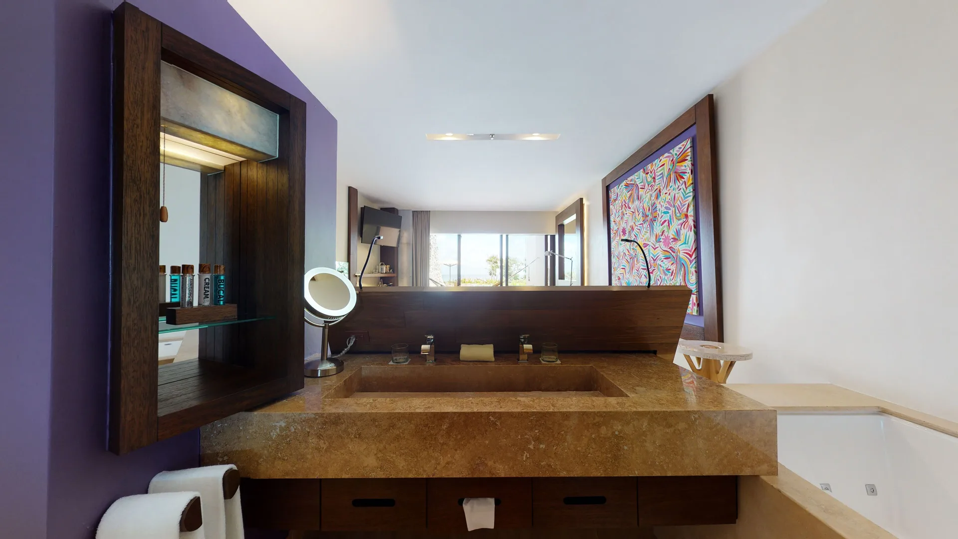 Bathroom vanity and soaking tub in an oceanfront swim-up room at Hotel Xcaret Arte.