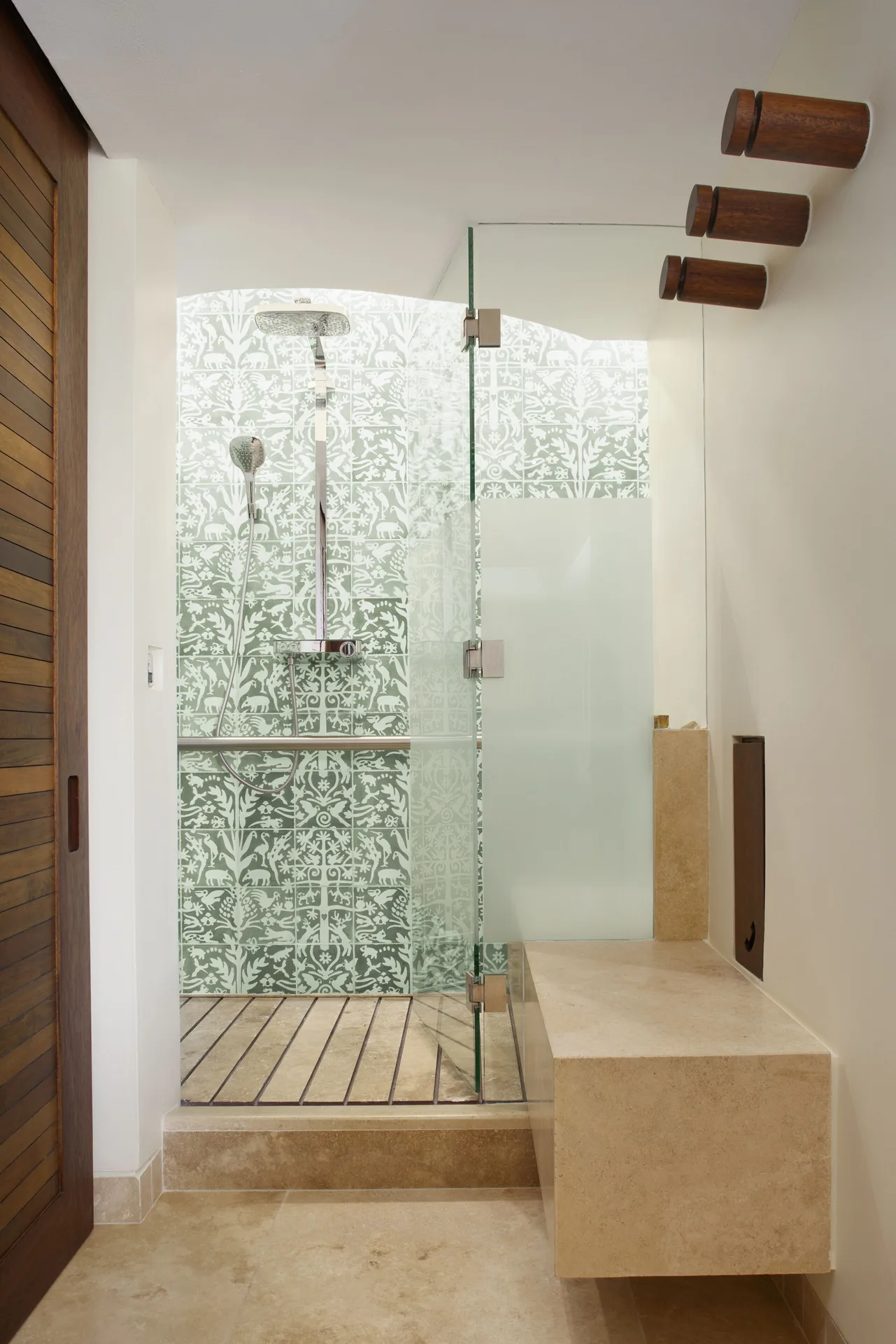 Garden suite bathroom shower with glass door and patterned tile at Hotel Xcaret Arte.