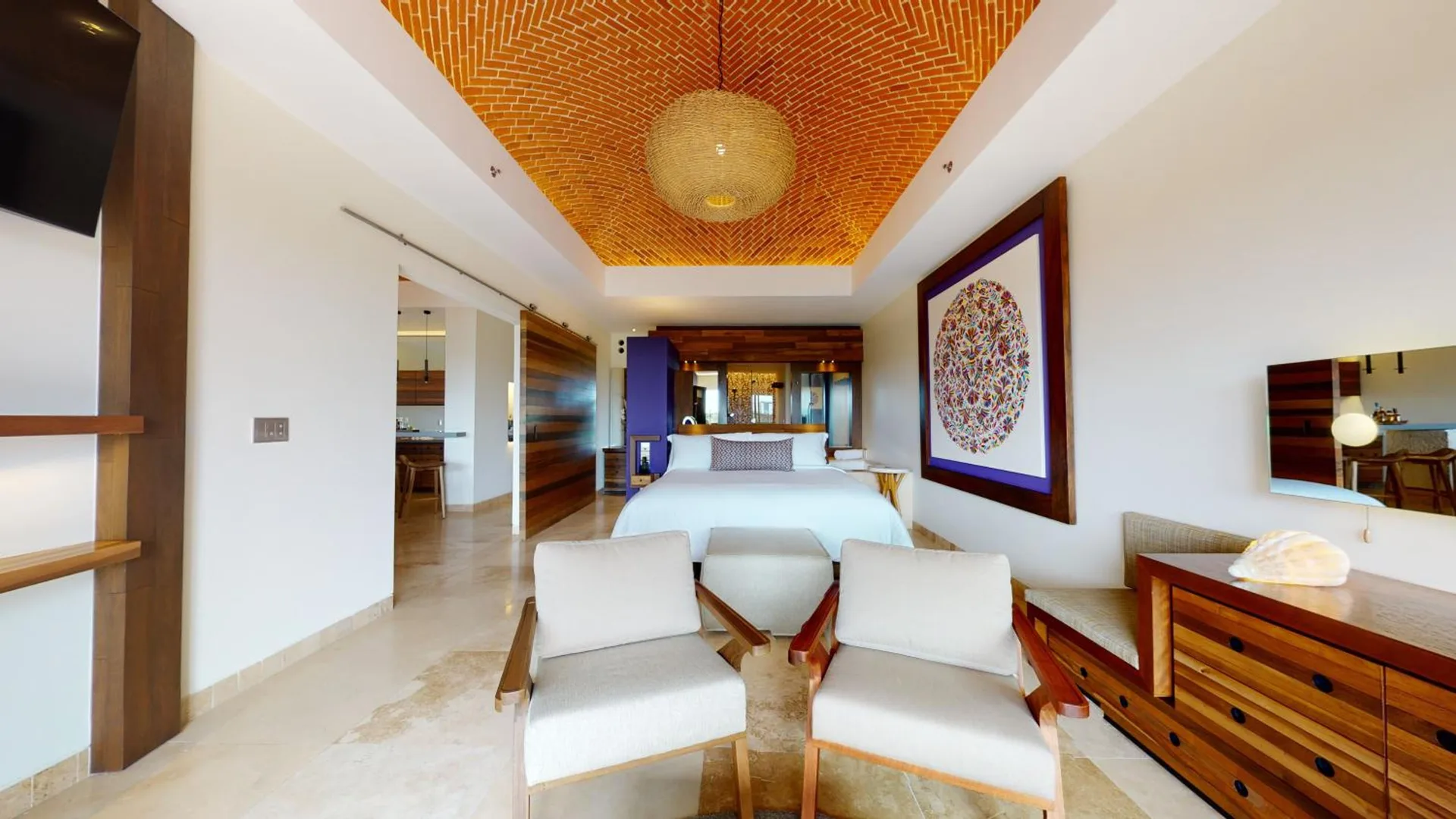River View suite king bed with seating area and vaulted brick ceiling at Hotel Xcaret Arte.