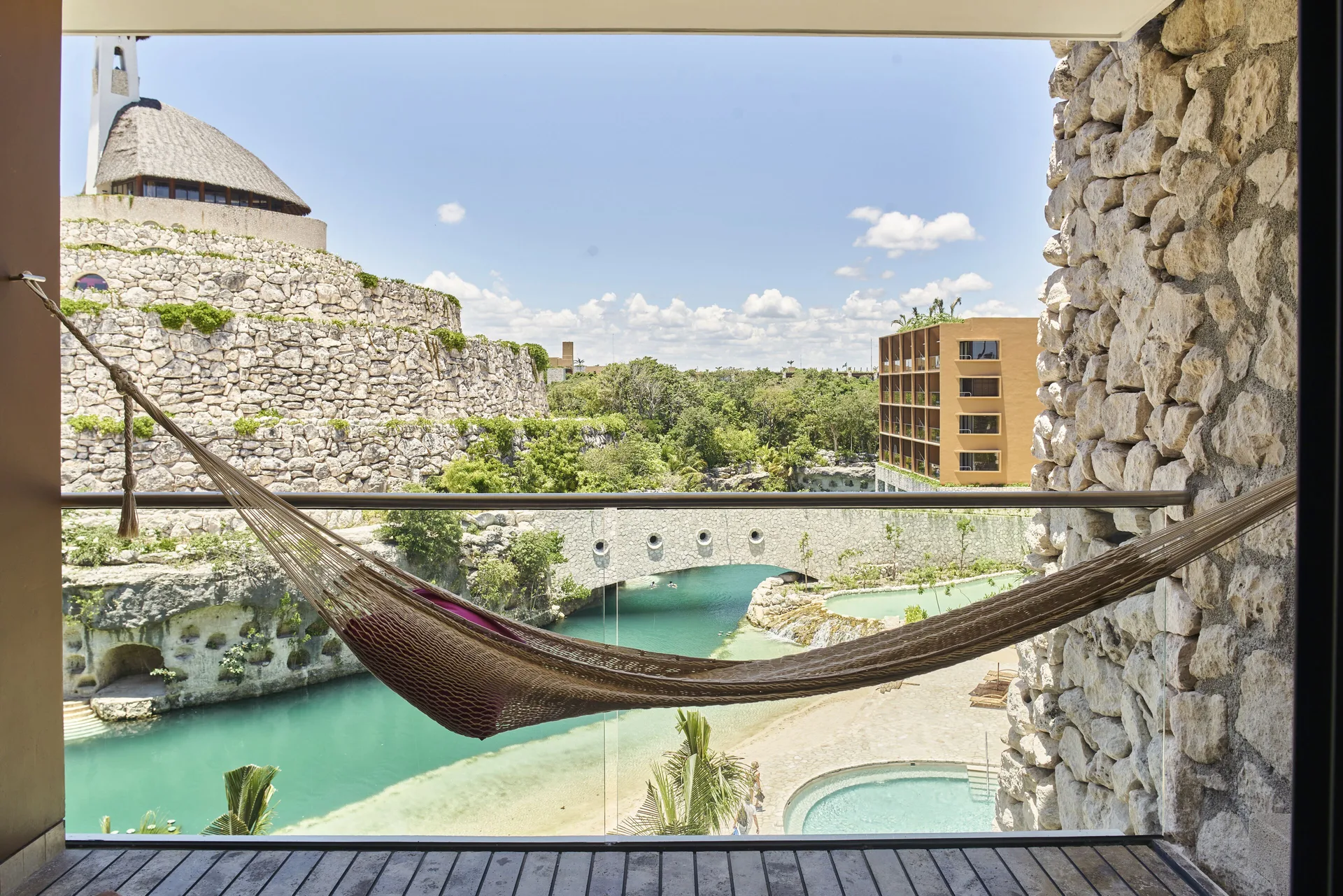 River suite balcony hammock with turquoise water views at Hotel Xcaret Arte.