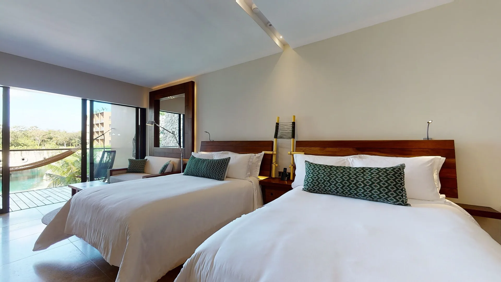 River suite with two beds and balcony view at Hotel Xcaret Arte.