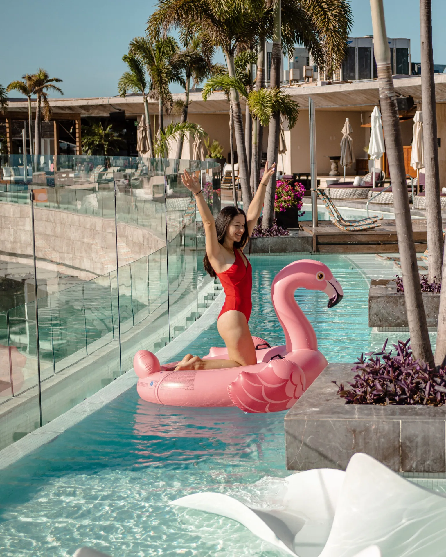 Guest on a pink flamingo float in the pool at Hyatt Centric Playa del Carmen - Downtown House & Beach House.