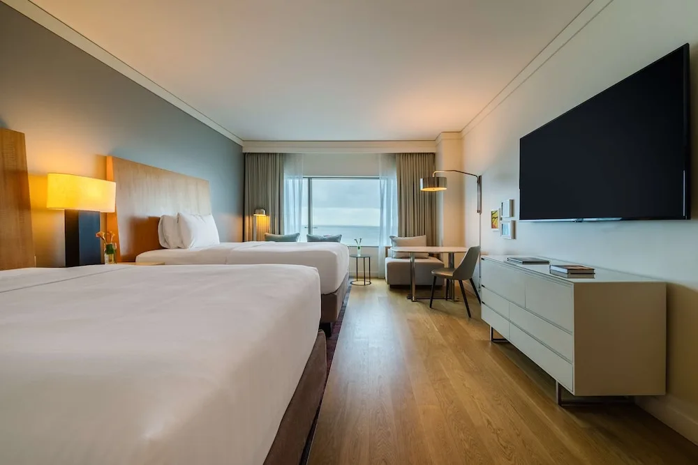 Two double beds and wall-mounted TV in a guest room at Hyatt Regency Trinidad.