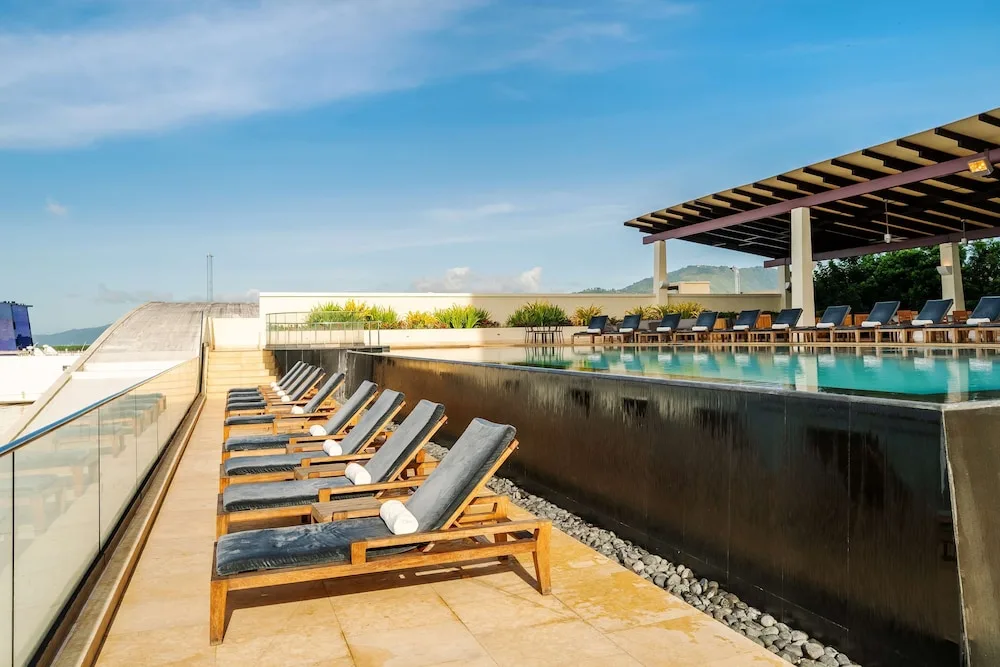 Pool deck loungers beside the raised infinity pool at Hyatt Regency Trinidad.