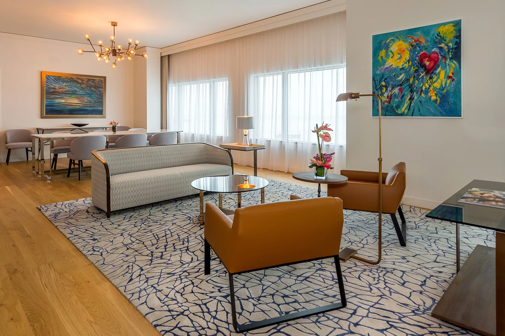 Suite sitting room with tan chairs, sofa and dining table at Hyatt Regency Trinidad.