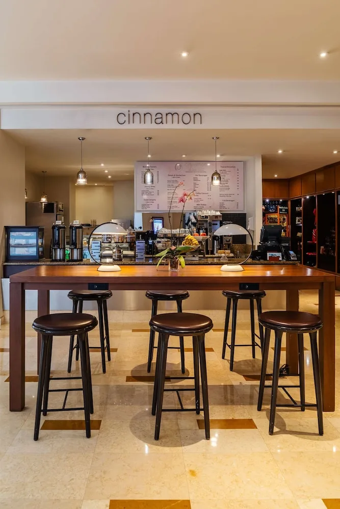 Cinnamon cafe counter with stools and menu boards at Hyatt Regency Trinidad.