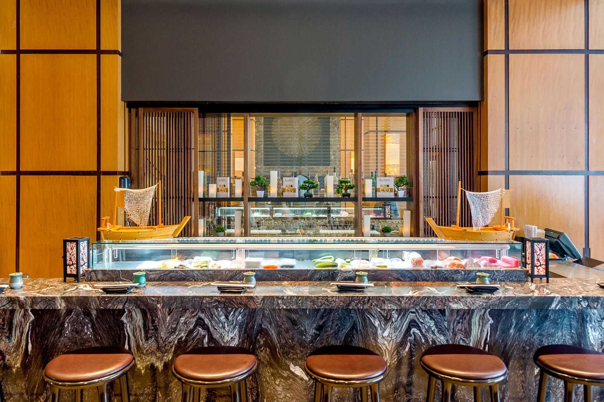 Sushi counter with display case and bar stools at Hyatt Regency Trinidad.