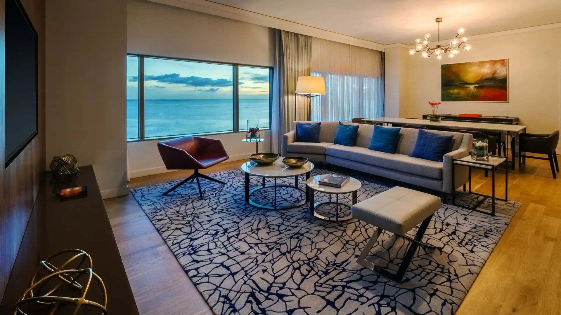 Ocean-view suite living room with sofa and dining area at Hyatt Regency Trinidad.
