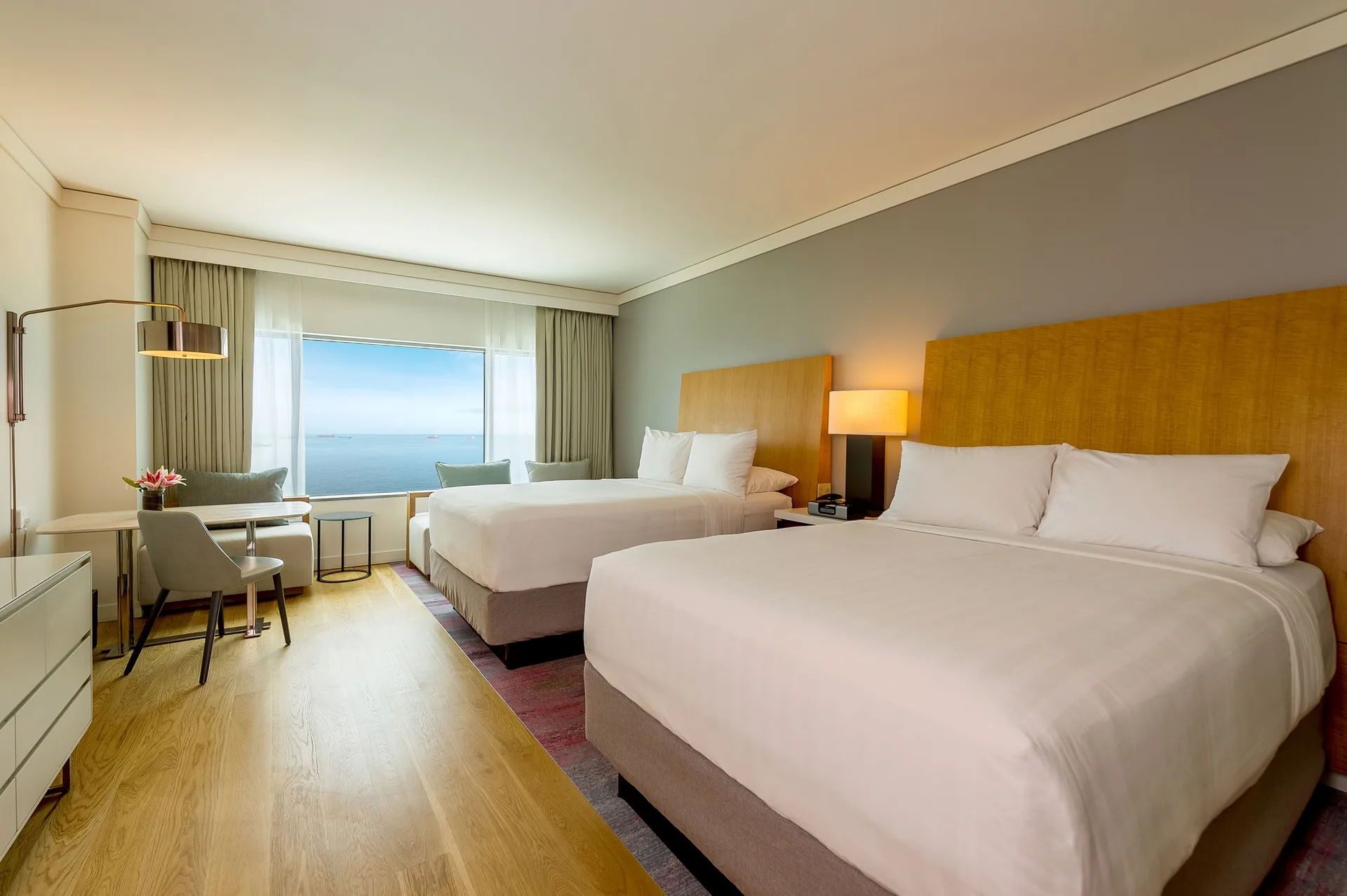 Two-bed guest room with ocean view window at Hyatt Regency Trinidad.