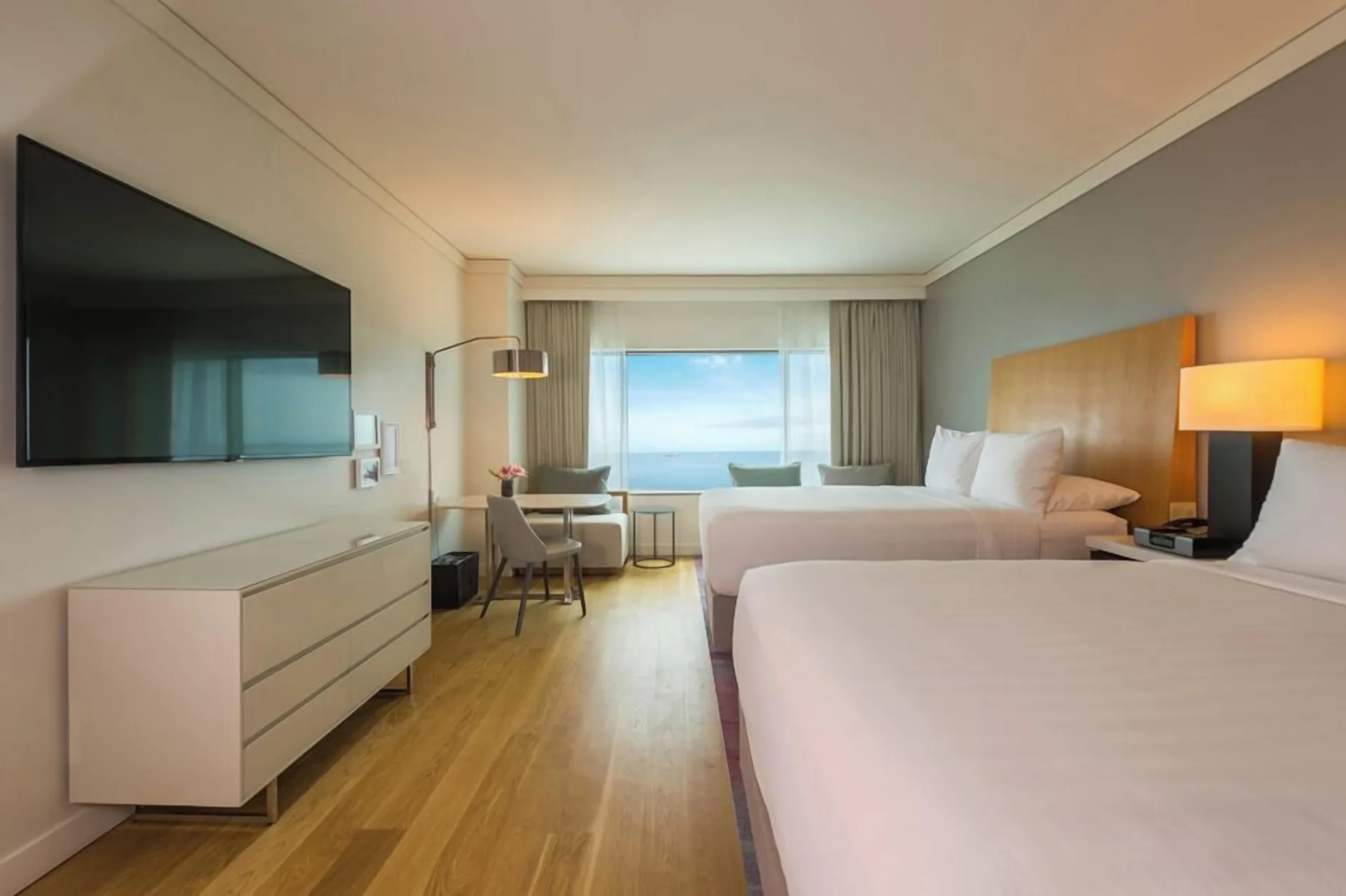 Two-bed guest room with wall-mounted TV and sea view at Hyatt Regency Trinidad.