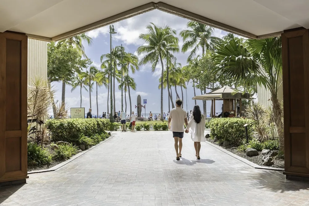 Palm-lined entrance walkway to Waikiki Beach at Hyatt Regency Waikiki Beach Resort & Spa.
