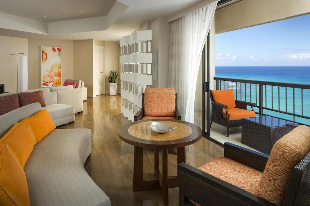 Ocean-view suite living area with balcony seating at Hyatt Regency Waikiki Beach Resort & Spa.
