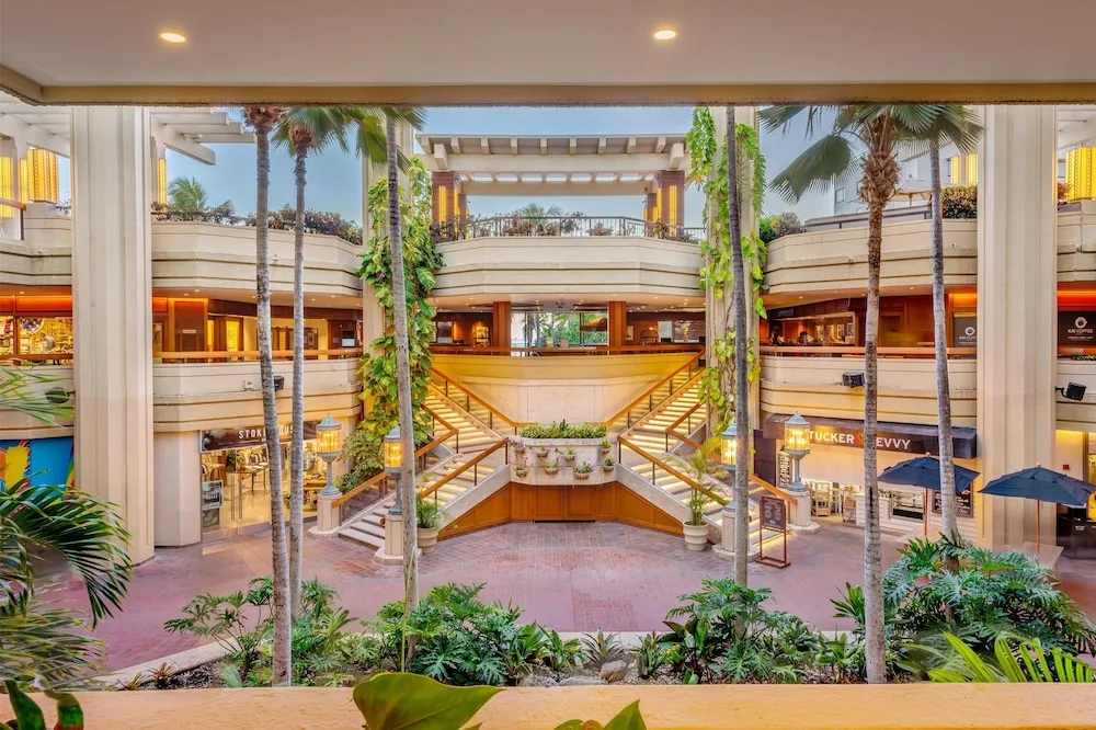Open-air atrium with shops and staircases at Hyatt Regency Waikiki Beach Resort & Spa.