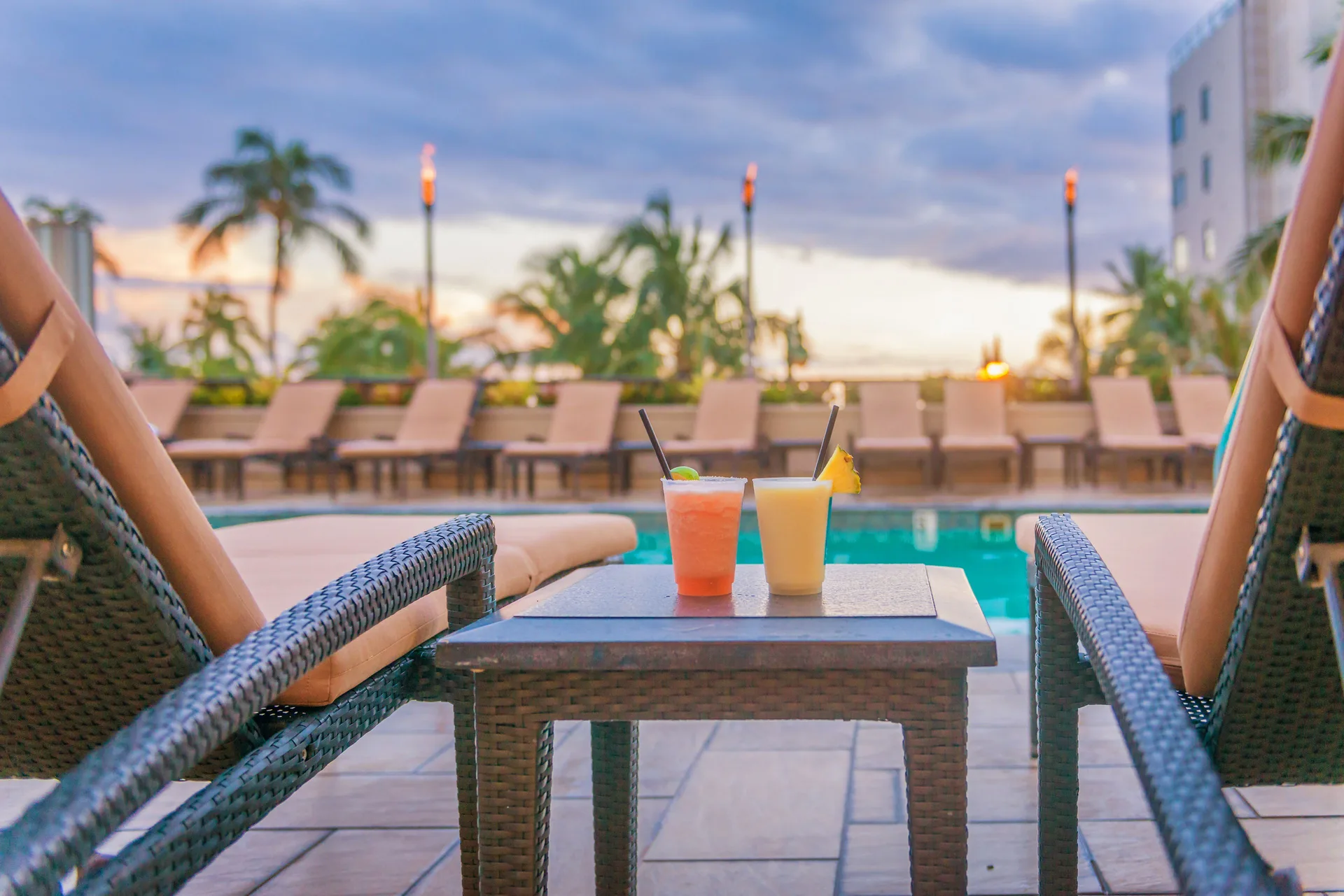 Poolside drinks and lounge chairs at Hyatt Regency Waikiki Beach Resort & Spa.