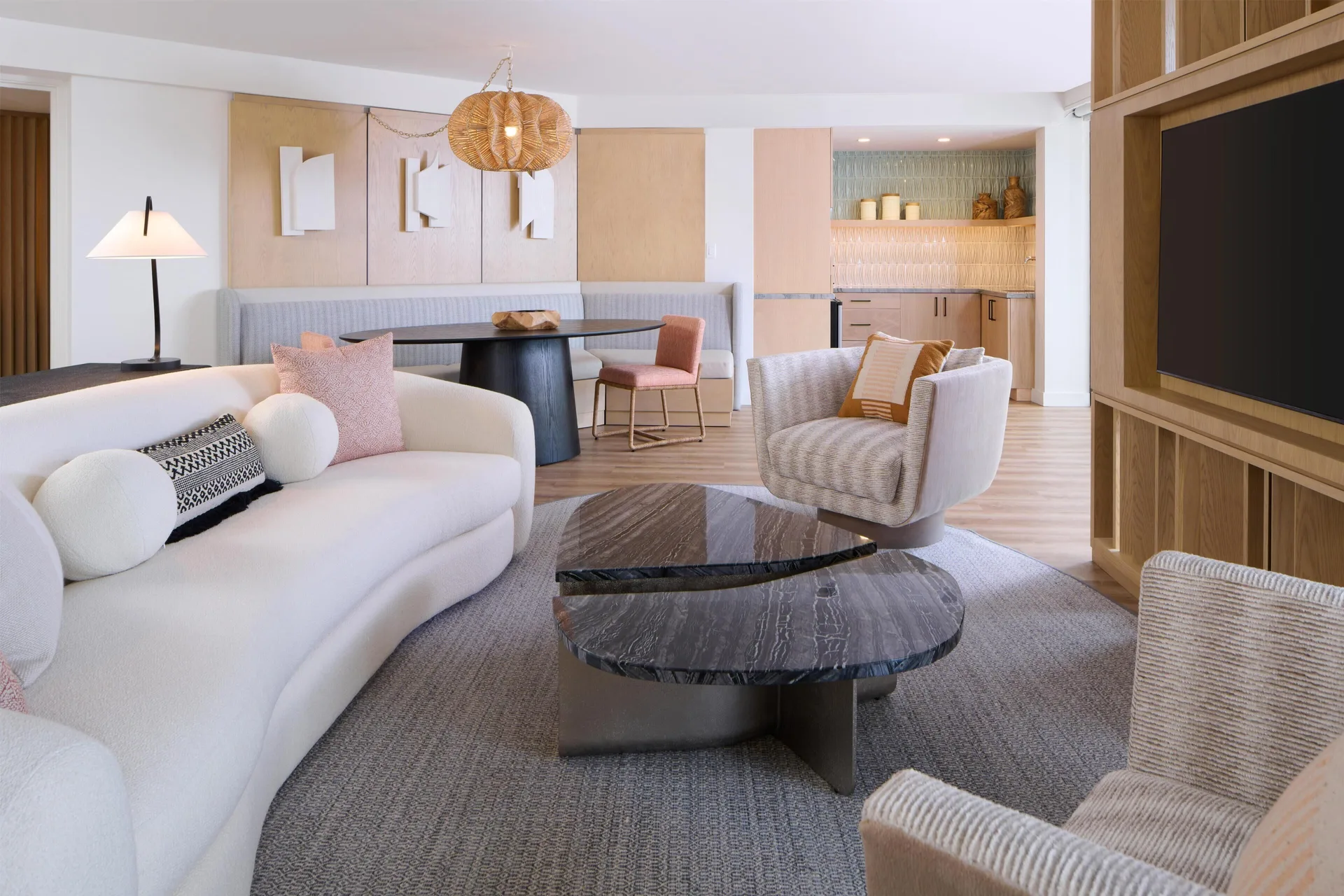 Deluxe suite lounge with sofa, chairs, TV, and wet bar at Hyatt Regency Waikiki Beach Resort & Spa.