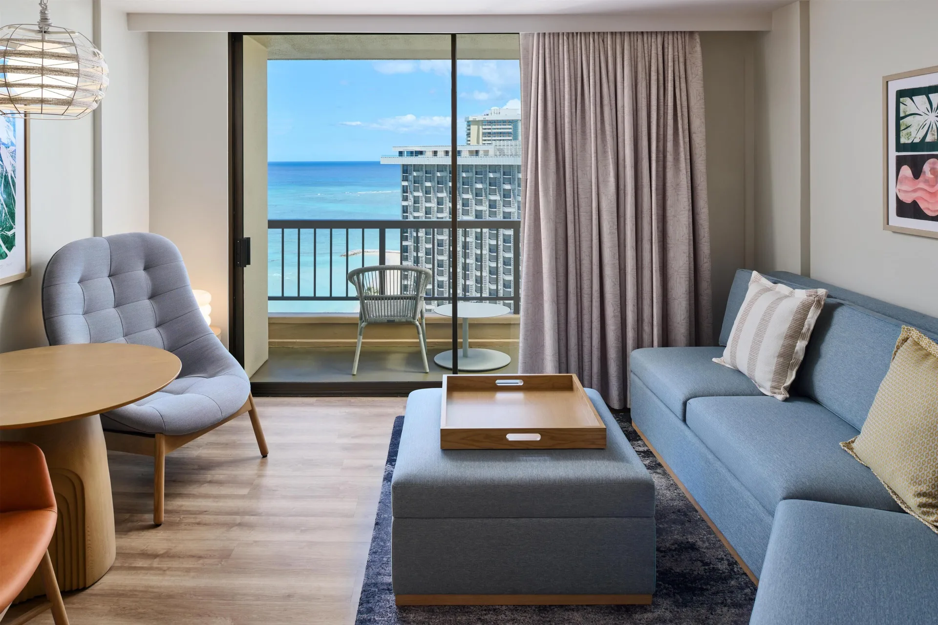 Junior Suite ocean-view sitting area with sofa bed at Hyatt Regency Waikiki Beach Resort & Spa.