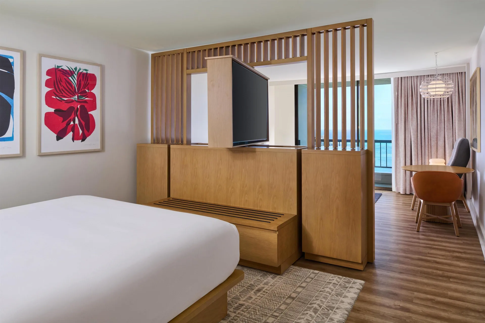 Junior Suite bedroom with wood divider and oceanfront sitting area at Hyatt Regency Waikiki Beach Resort & Spa.