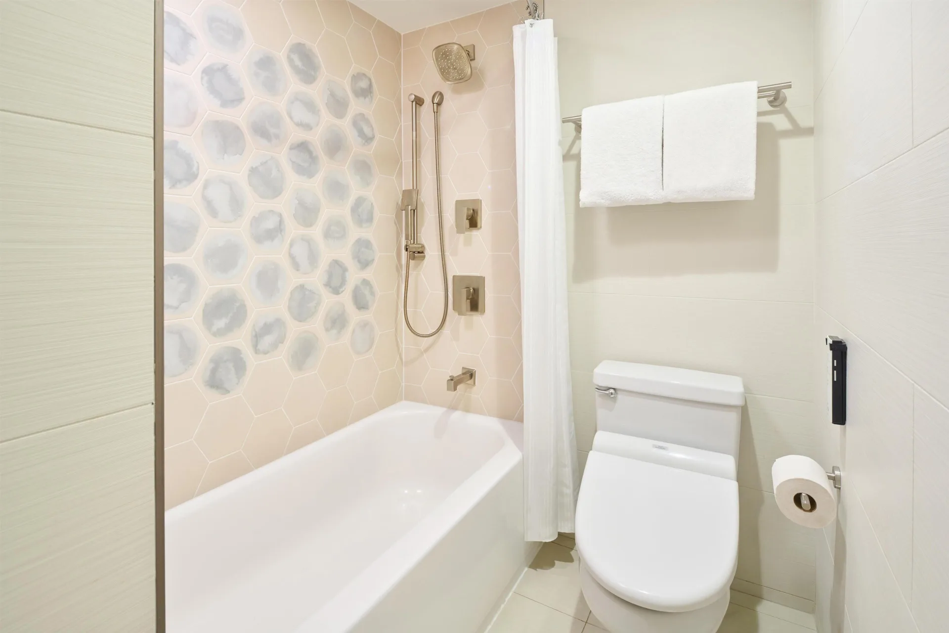 Junior suite bathroom with tub and shower at Hyatt Regency Waikiki Beach Resort & Spa.